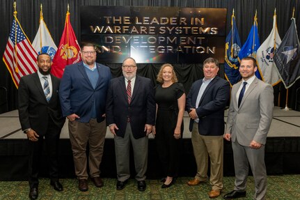 IMAGE: Winners of the Reuben S. Pitts Leadership Award pose with Pitts after the Naval Surface Warfare Center Dahlgren Division Annual Honorary Awards ceremony at the Fredericksburg Expo Center March 10. Pictured from left to right, Gavin Harris, Ryan Berg, Reuben S. Pitts III, Kendra Miller, Christopher Reasonover and Brent Steffey.