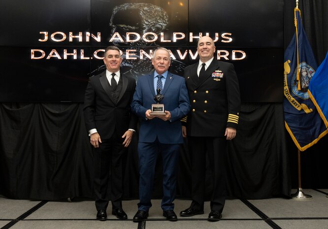 IMAGE: Naval Surface Warfare Center Dahlgren Division (NSWCDD) Technical Director Dale Sisson Jr., SES, and Commanding Officer Capt. Philip Mlynarski presented James McConkie with the John Adolphus Dahlgren Award during the NSWCDD Annual Honorary Awards ceremony at the Fredericksburg Expo Center March 10. McConkie won the award for his body of work providing lasting institutional benefit to NSWCDD.