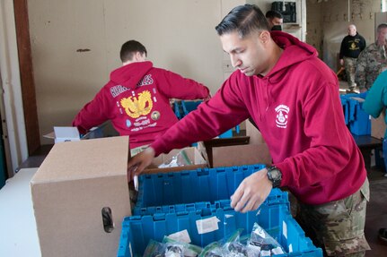 Virginia National Guard Warrant Officer Candidates complete their community service project at the Vietnam Veterans of America Chapter 806 food bank March 11, 2023, at Fort Pickett, Virginia. The WOCs are part of Class 23-001, instructed by cadre assigned to the Fort Pickett-based Warrant Officer Candidate School, 3rd Battalion, 183rd Regiment, Regional Training Institute. WOCS requires each class to identify, plan, and execute a community service project prior to moving on to the final phase of WOCS. Completion of the community service project provides the candidates an opportunity to demonstrate teamwork, while also practicing many of the same tasks and skills necessary to plan and execute military operations. (U.S. National Guard photos by Staff Sgt. Marc Heaton)