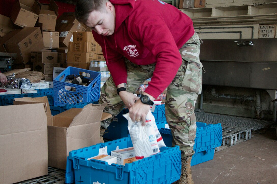 Virginia National Guard Warrant Officer Candidates complete their community service project at the Vietnam Veterans of America Chapter 806 food bank March 11, 2023, at Fort Pickett, Virginia. The WOCs are part of Class 23-001, instructed by cadre assigned to the Fort Pickett-based Warrant Officer Candidate School, 3rd Battalion, 183rd Regiment, Regional Training Institute. WOCS requires each class to identify, plan, and execute a community service project prior to moving on to the final phase of WOCS. Completion of the community service project provides the candidates an opportunity to demonstrate teamwork, while also practicing many of the same tasks and skills necessary to plan and execute military operations. (U.S. National Guard photos by Staff Sgt. Marc Heaton)