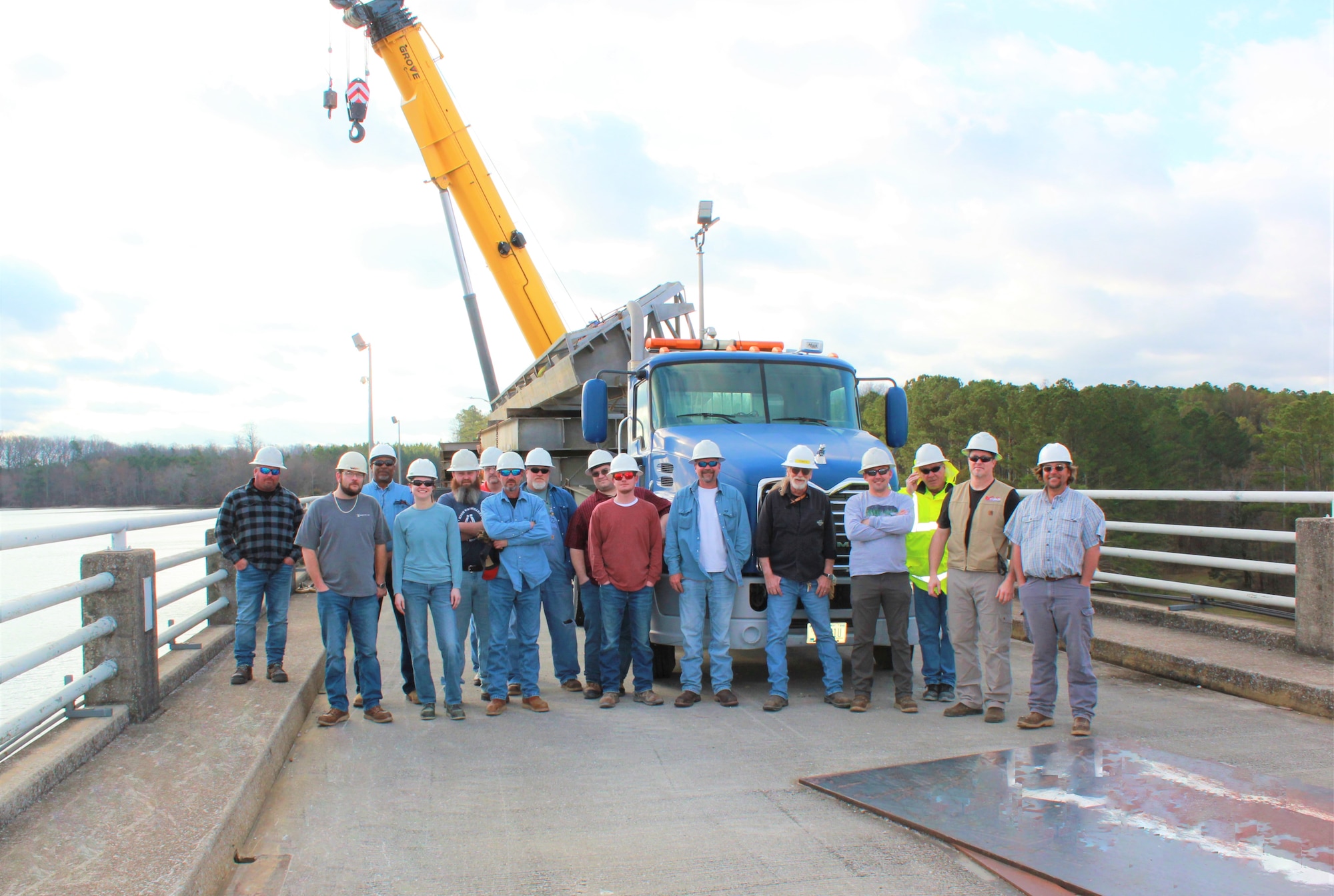 The crane and rigging crew at Arnold Air Force Base, Tenn., poses for a photo atop Elk River Dam Feb. 22, 2023. The crew recently completed a preventative maintenance project at the dam to ensure gates and other equipment remain in good working order. This work is performed each winter to prevent disturbances to the gray bat population residing at the dam, as the bats migrate to caves during the winter months. (U.S. Air Force photo)