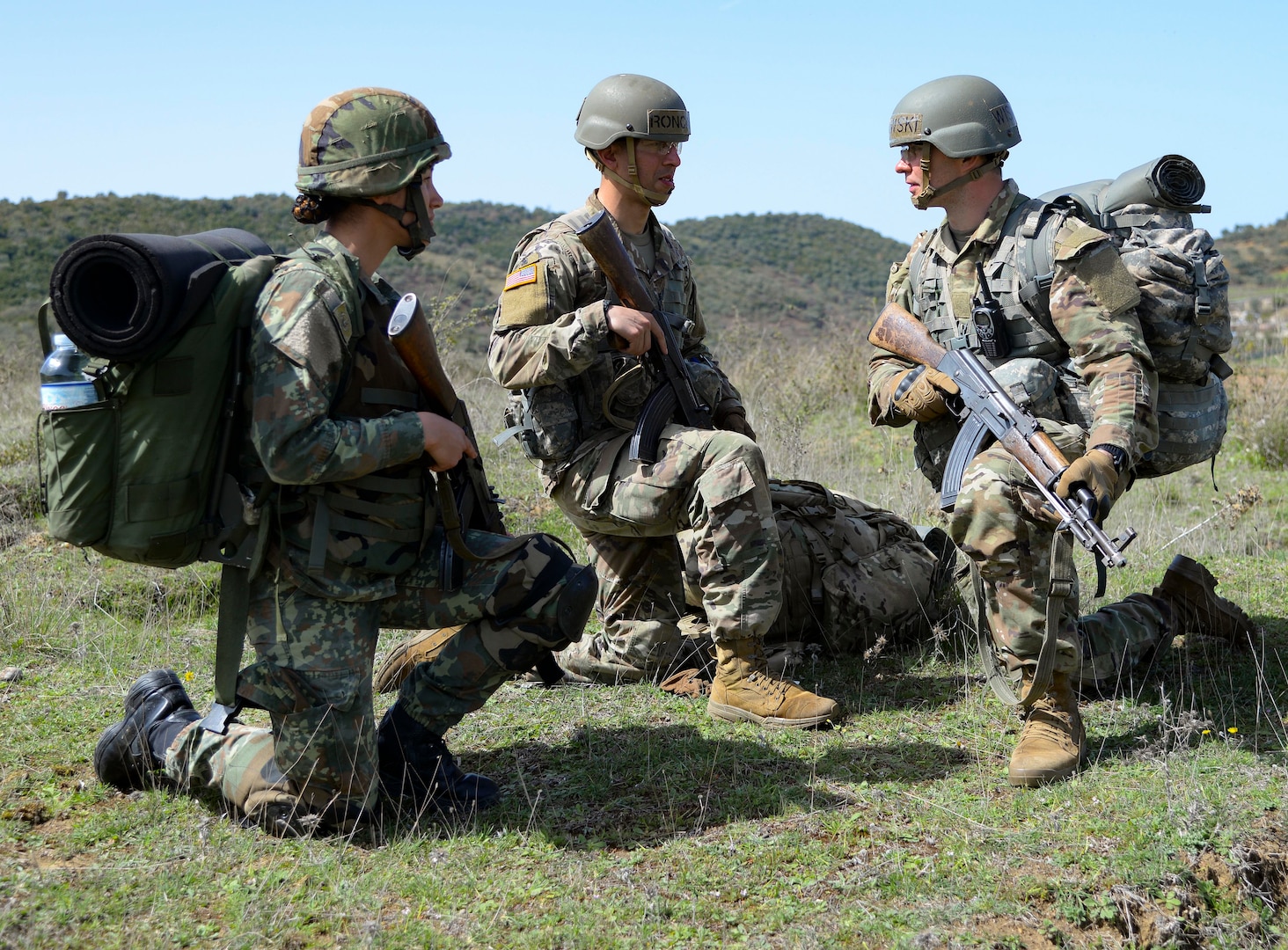 Albanian Armed Forces officer candidate Besmilvini Kolchi, left, speaks with New Jersey National Guard officer candidates Asturias Roncol and Michael Wisniewski during tactics training at the Bunavi Individual Training Center, April 6, 2022, in Vlorë, Albania. The New Jersey National Guard Officer Candidate School will return to Albania April 10-24, 2023, to train as part of their State Partnership Program relationship with Albania, with five New York Army National Guard officer candidates invited to participate.