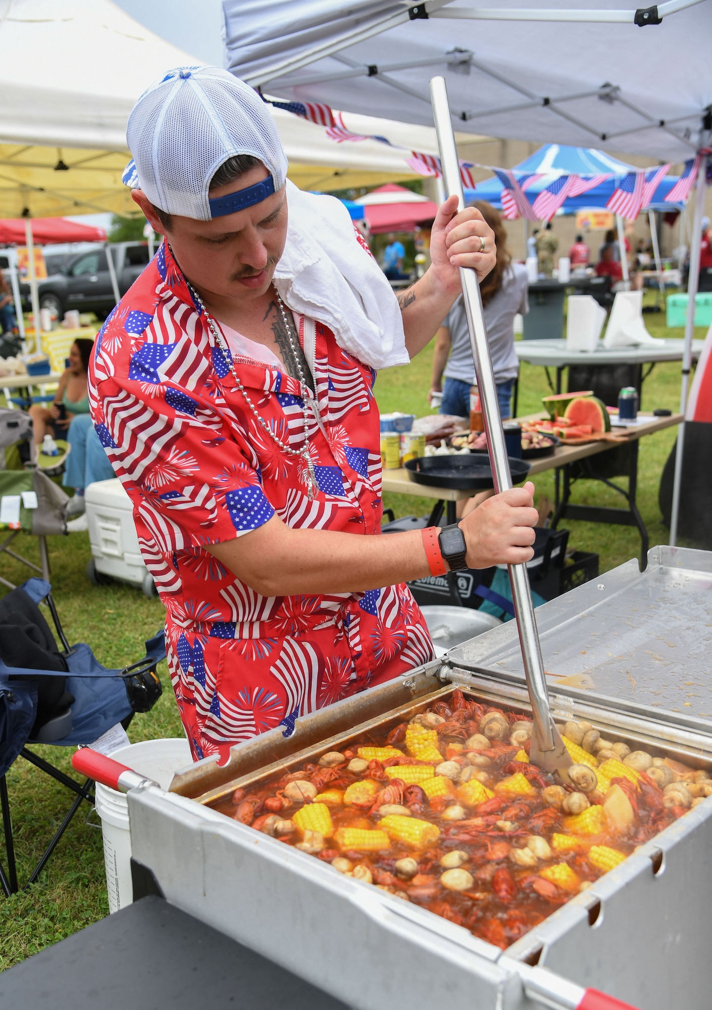 U.S. Navy Chief Wesley Ward, Information Warfare Training Command Keesler information system technician, from the Founding Crawfathers team, stirs his pot of boiled crawfish during the 11th Annual Crawfish Cook-Off outside the Bay Breeze Event Center at Keesler Air Force Base, Mississippi, March 24, 2023.