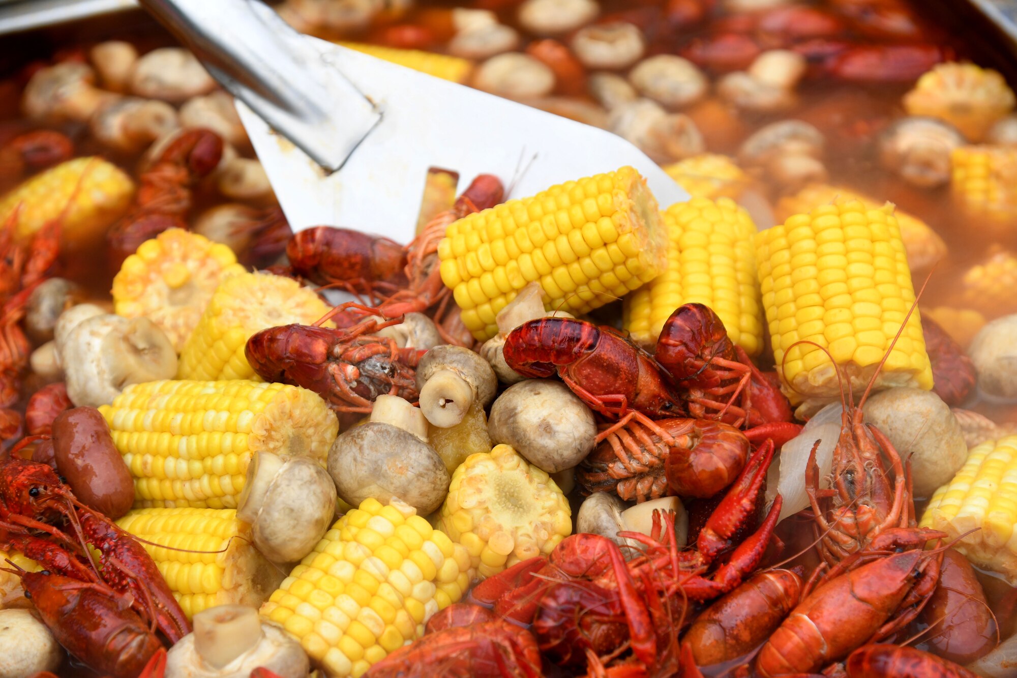 U.S. Navy Chief Wesley Ward, Information Warfare Training Command Keesler information system technician, Founding Crawfathers team members, stirs his pot of boiled crawfish during the 11th Annual Crawfish Cook-Off outside the Bay Breeze Event Center at Keesler Air Force Base, Mississippi, March 24, 2023.