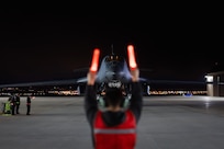 Maintainers from the 28th Aircraft Maintenance Squadron marshall a B-1B Lancer into position  after it returns from Nellis Air Force Base, Nevada, at Ellsworth AFB, South Dakota, March 24, 2023.