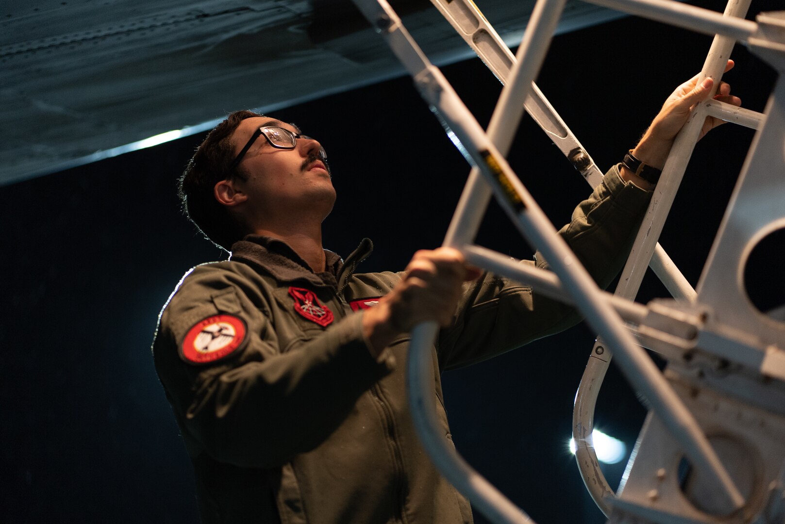 Capt. Colin Blount, 34th Bomb Squadron air crew member, unloads cargo from a B-1B Lancer upon returning from Nellis Air Force Base, Nevada, at Ellsworth AFB, South Dakota, March 24, 2023.