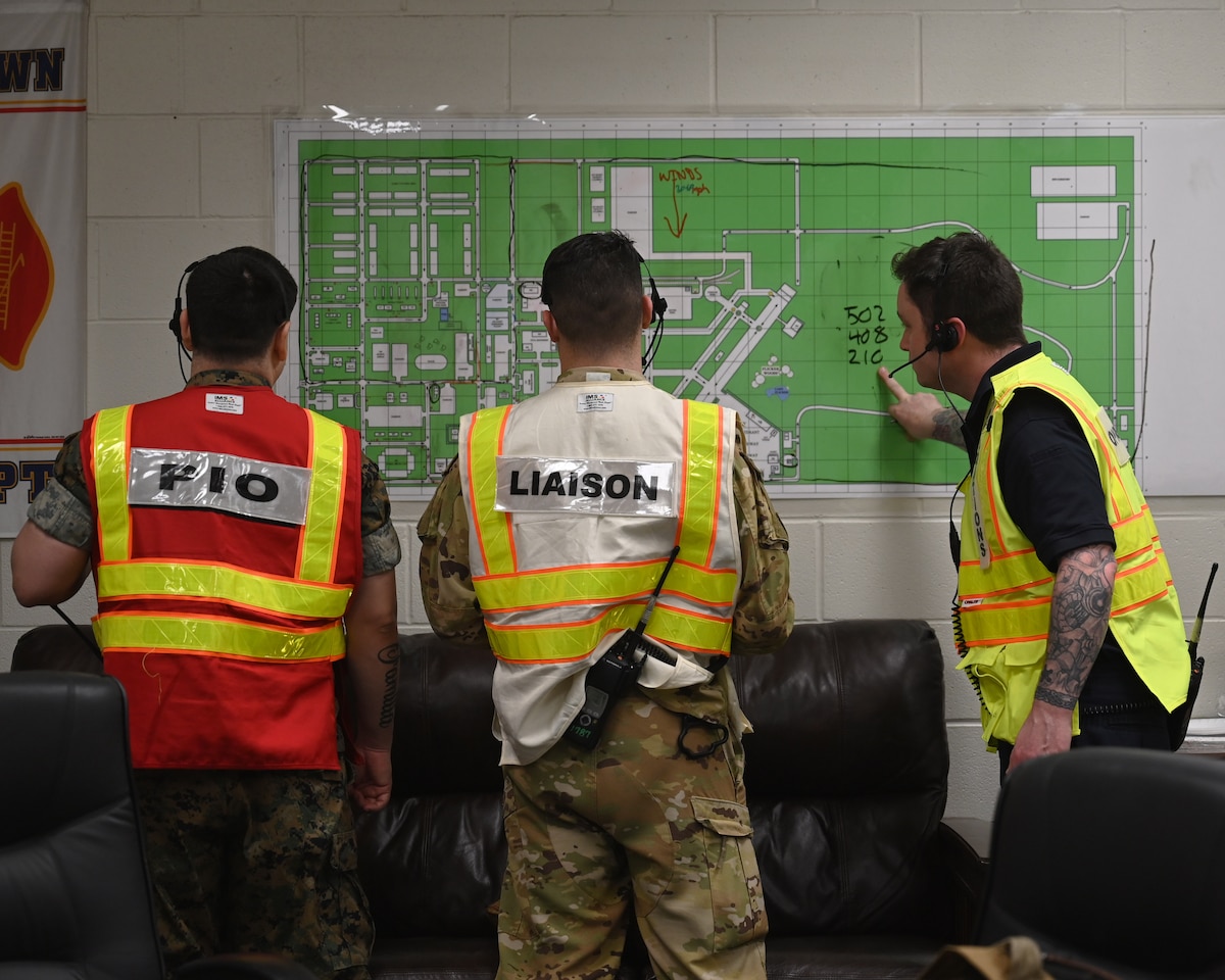 A group of Fire Officer 3 students utilize a map to determine what resources are needed during an exercise at Goodfellow Air Force Base, Texas, March 21, 2023. The Incident Command Post communicates with the team in the disaster area to get a total picture view of the affected area. (U.S. Air Force photo by Airman 1st Class Zach Heimbuch)