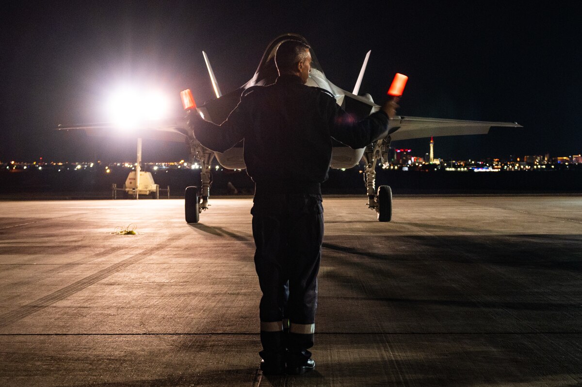 An Israeli Air Force member marshals an F-35I Adir to its spot after a Red Flag-Nellis 23-2 mission at Nellis Air Force Base, Nevada, March 16, 2023.