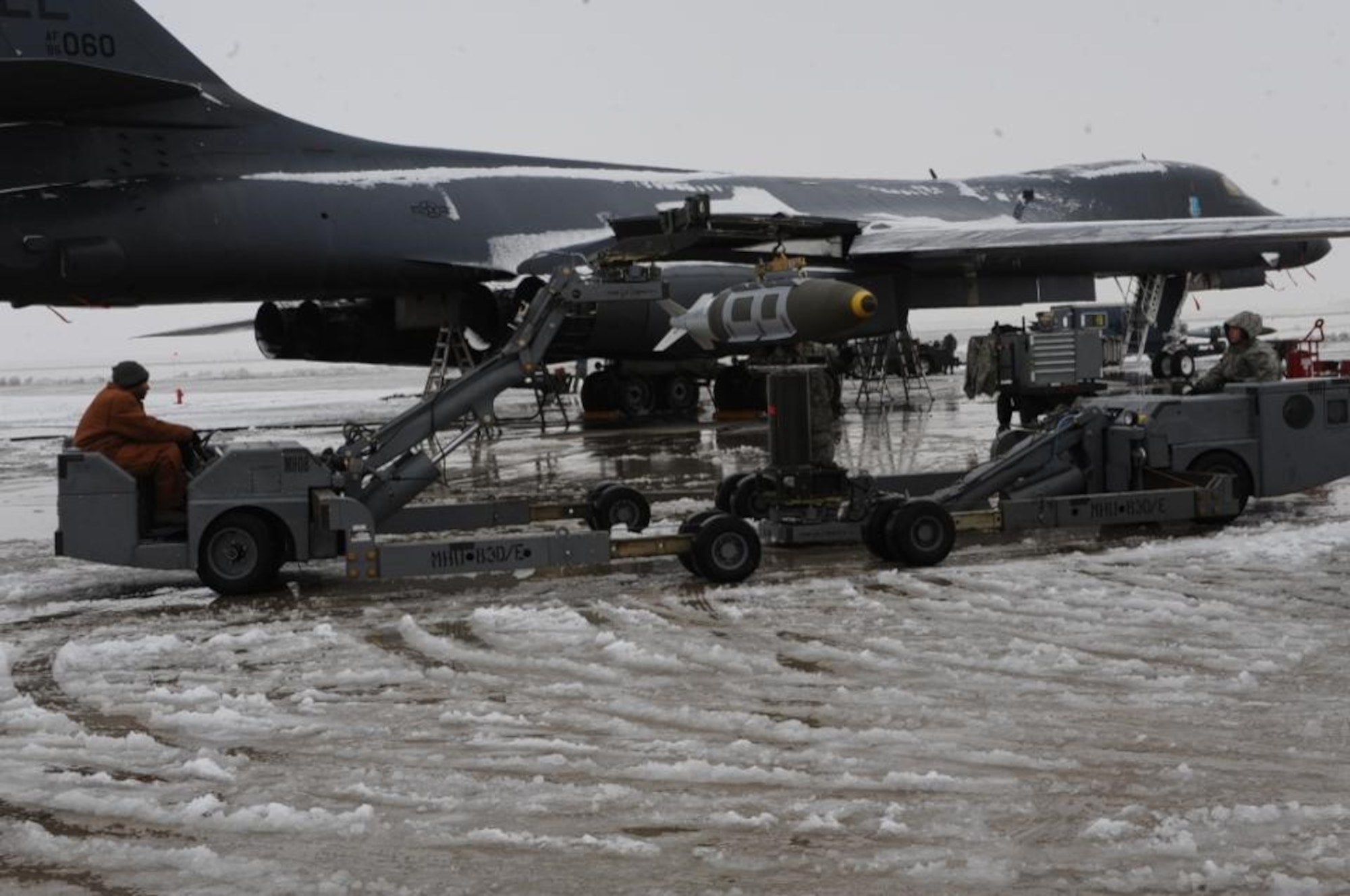 U.S. Air Force Airmen, assigned to the 28th Bomb Wing, load a joint direct attack munition onto a B-1B Lancer at Ellsworth Air Force Base, South Dakota, in support of Operation Odyssey Dawn, March 2011.