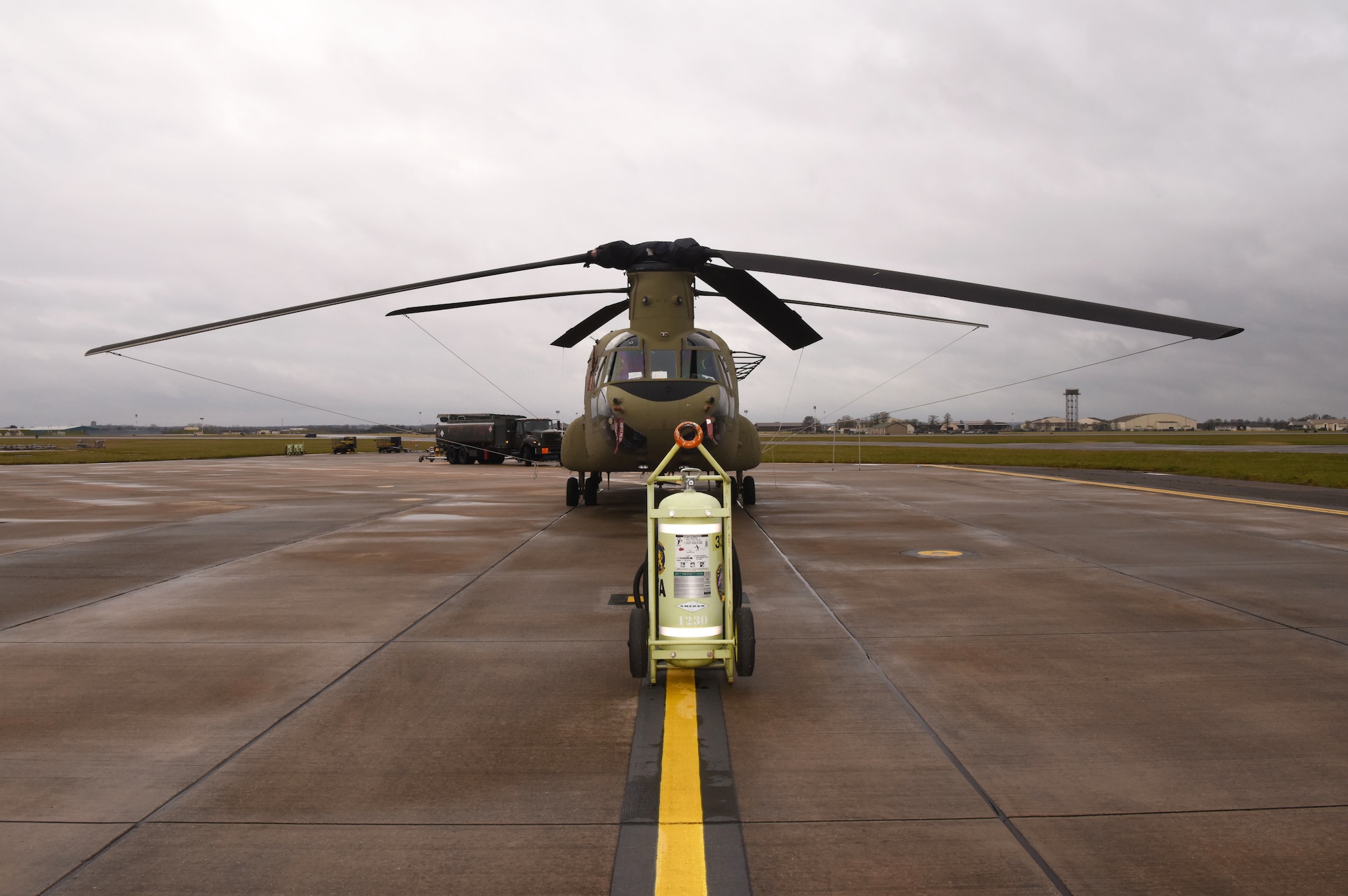 A U.S. Army CH-47F Chinook helicopter from the 1st Battalion, 214th Aviation Regiment (General Support Aviation Battalion), 12th Combat Aviation Brigade, Wiesbaden, Germany, sits on the flightline at Royal Air Force Mildenhall, England, March 16, 2023. The 12 CAB is among other units assigned to V Corps, America's Forward Deployed Corps in Europe. They work alongside NATO Allies and regional security partners to provide combat-ready forces, execute joint and multinational training exercises, and retain command and control for all rotational and assigned units in the European theater. (U.S. Air Force photo by Karen Abeyasekere)