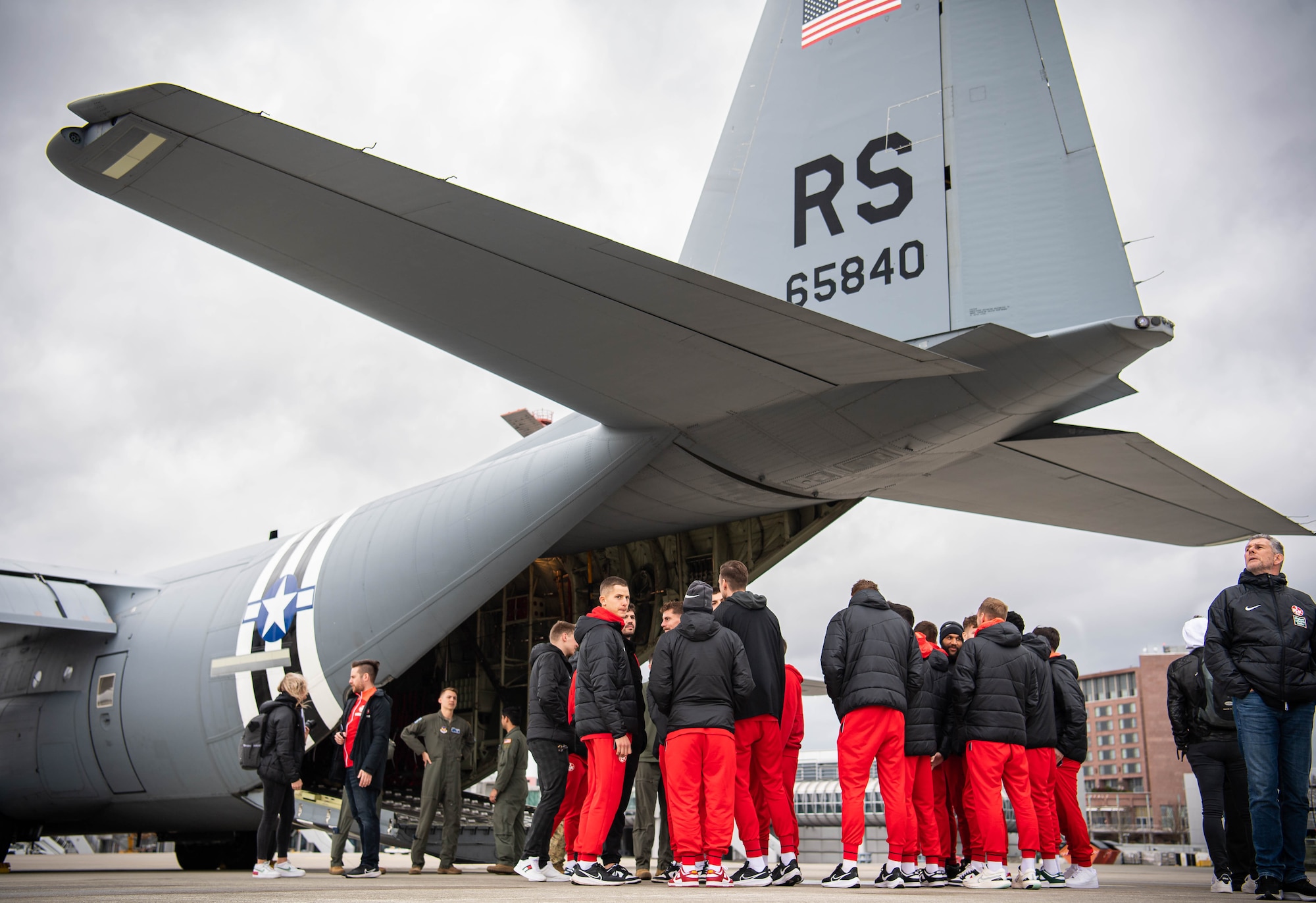 Football Club Kaiserslautern (1. FCK) players and coaches are shown a C-130J Super Hercules aircraft assigned to the 37th Airlift Squadron, at Ramstein Air Base, Germany, March 23, 2023. Members and coaches from 1.FCK visited RAB and experienced a base tour that highlighted many of the missions housed here. (U.S. Air Force photo by Airman 1st Class Jared Lovett)