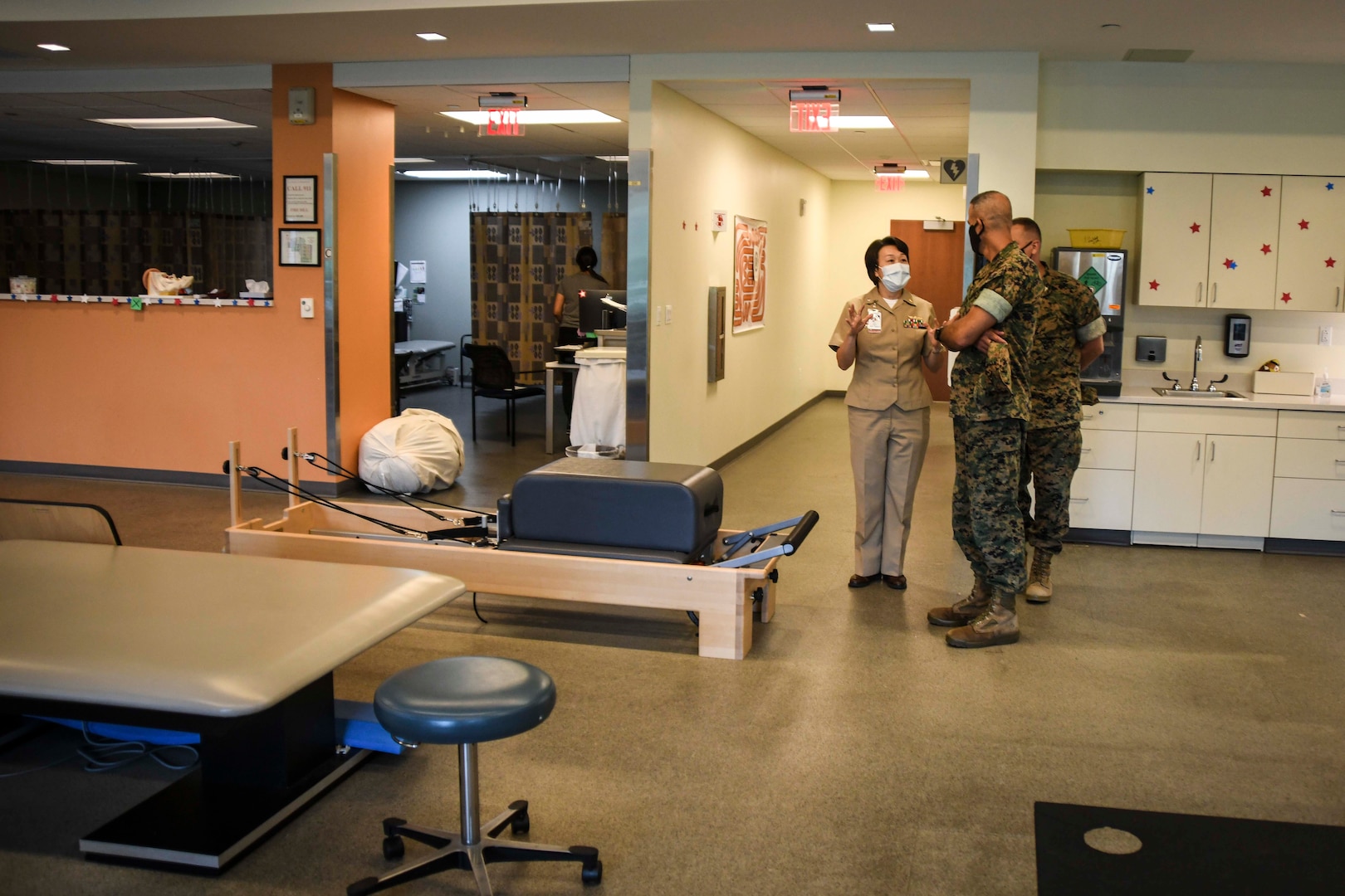 In a photo dated August 2, 2021, U.S. Navy Commander Diana Fu explains the physical therapy room at Intrepid Spirit Concussion Recovery Clinic to Marine Corps Installations East Commander