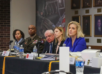 Secretary of the Army Christine Wormuth sits at panel table with four other panel members.