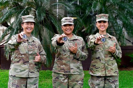 From left to right, CMSgt Carol Orr, Command Chief for HQ 154th Wing, CMSgt Zandra Fox, Command Senior Enlisted Leader for Hawaii National Guard, and CMSgt Mey Martin, State Command Chief, Hawaii Air National Guard display their coin given by Senior Enlisted Advisor Tony Whitehead, the SEA to the chief of the National Guard Bureau.