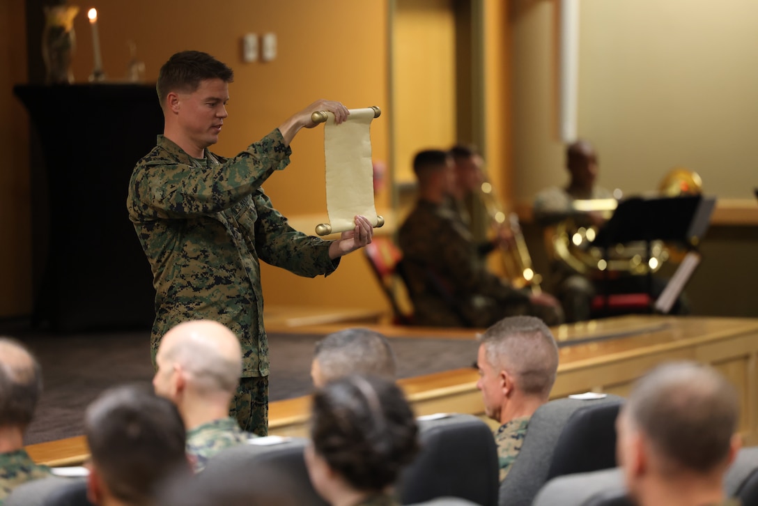Marine Forces Special Operations Command hosts a cake cutting ceremony in celebration of the 247th Marine Corps Birthday at Camp Lejeune, North Carolina, Nov. 10, 2022. It is a Marine Corps Birthday tradition for the oldest and youngest Marine present to share the first slice of cake. Col. Richard Hansen, chief of staff, passed the slice to Lance Cpl. Robert W. Holman, symbolizing the passing of wisdom, knowledge, and experience as well as trust and confidence in those who will carry on our Marine Corps traditions in the future. (U.S. Marine Corps photo by Sgt. Jesula Jeanlouis)