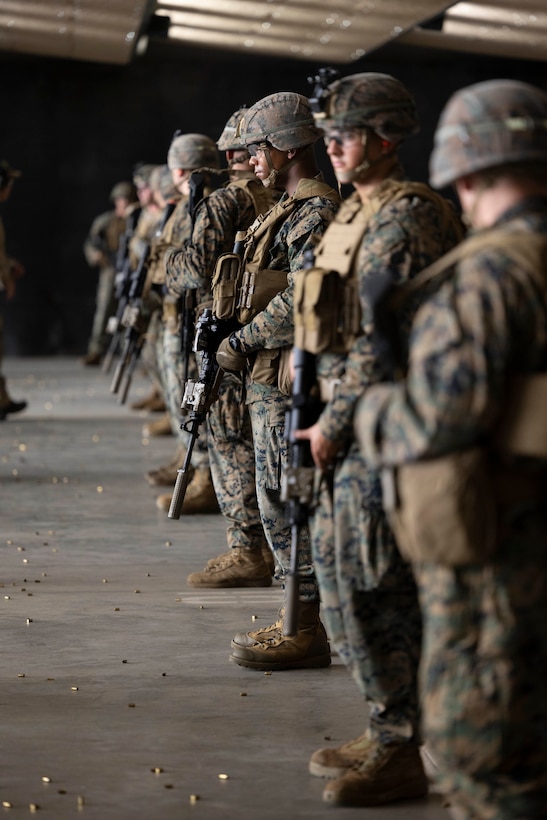 Marines with 1st Battalion, 8th Marines stand by on the firing line during a static shooting drill at Camp Lejeune, North Carolina, Aug. 28 – Sept. 9, 2022. The training, conducted with Marine Forces Special Operations Command, included static and moving drills, single and multi-room clears, and full team house runs. This allows for better integration between Special Operations Forces and Fleet Marine Force assets to unite tactical and operational efforts and create a healthy environment of interdependence on the battlefield and for the future operating environment. (U.S. Marine Corps photo by Sgt. Jesula Jeanlouis)