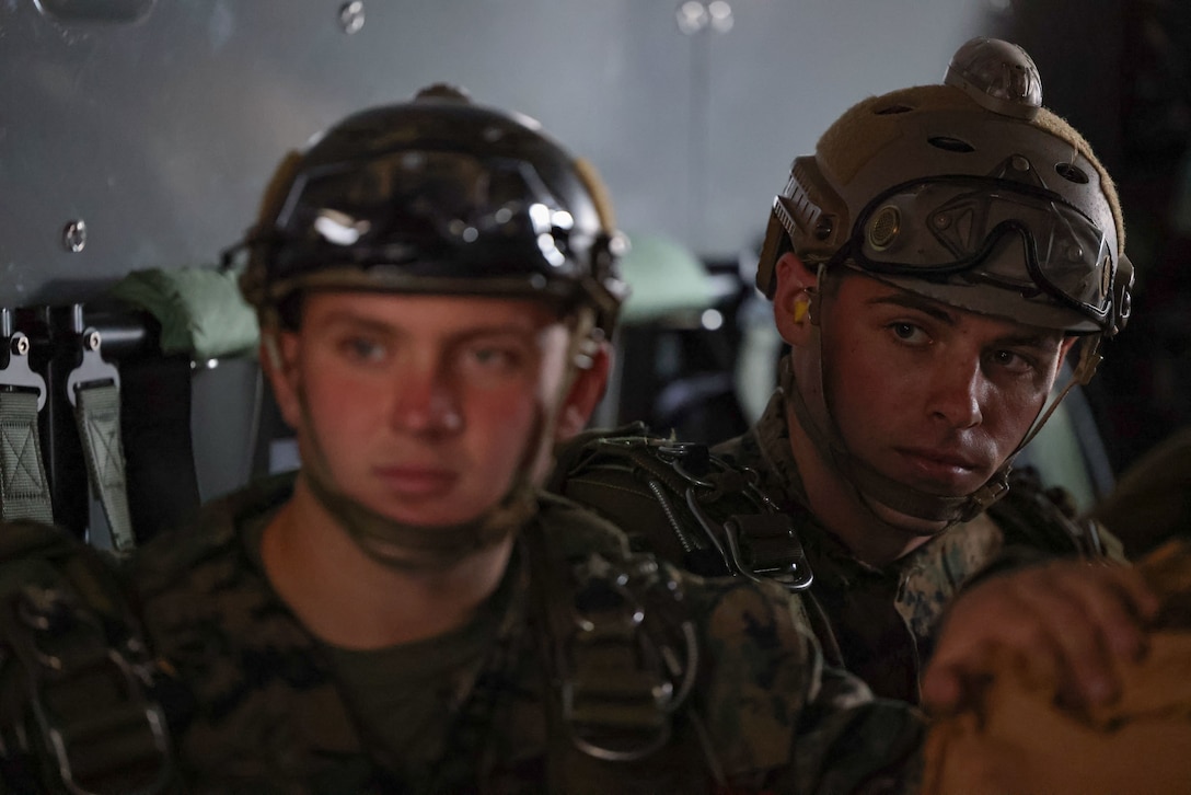 Marines with Marine Forces Special Operations Command receive instruction prior to performing static line-parachute jumps during an evaluation of the CH-53K King Stallion helicopter in the vicinity of Marine Corps Air Station Cherry Point, Oct. 26, 2022. The evaluation included day and night aerial cargo delivery, low-level static line parachute operations, and military freefall operations. (U.S. Marine Corps photo by Sgt. Jesula Jeanlouis)