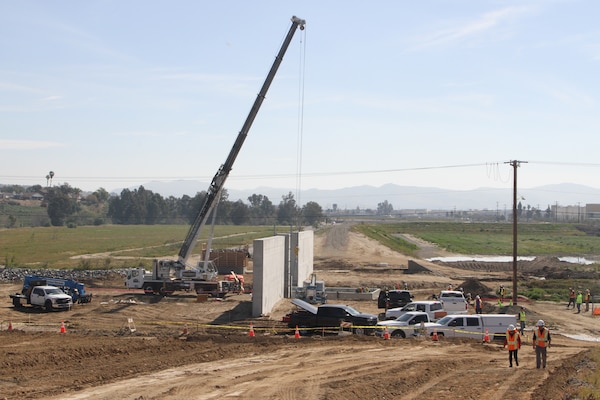 A crane is prepped before the installation of a 19-ton floodgate March 10 on the Alcoa Dike alongside the Temescal Wash in Corona, California.