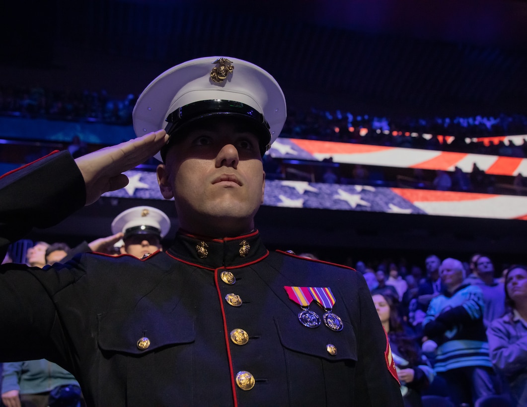 Marines of the Silent Drill Platoon, Marine Barracks Washington, salute during a Seattle Krakens hockey game in Seattle Washington., March 11, 2023. The performance was part of the annual Battle Color Detachment Tour, extending along the west coast.