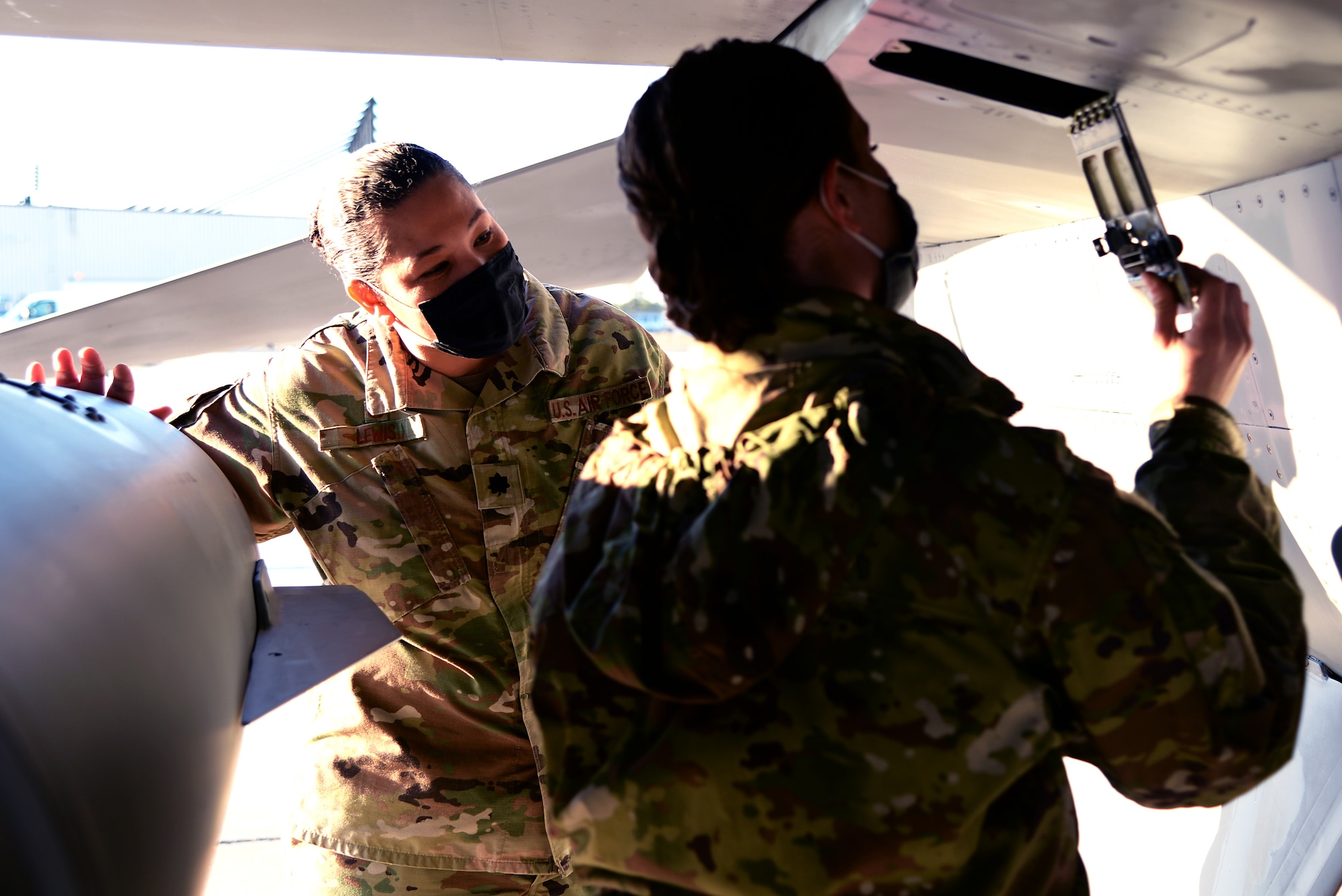 A photo of maintainers inspecting an aircraft.