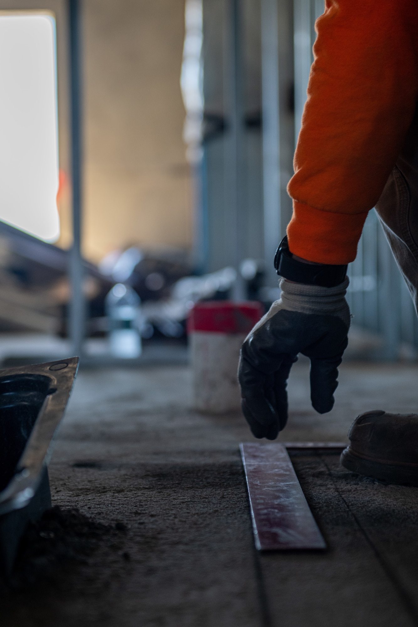 A construction worker takes measurements