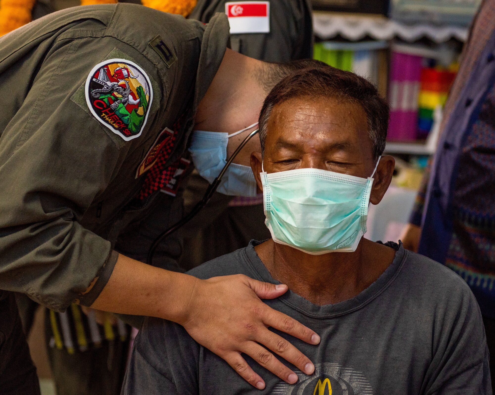 Photo of a U.S. Air Force flight surgeon examination a patient during a civic action engagement.