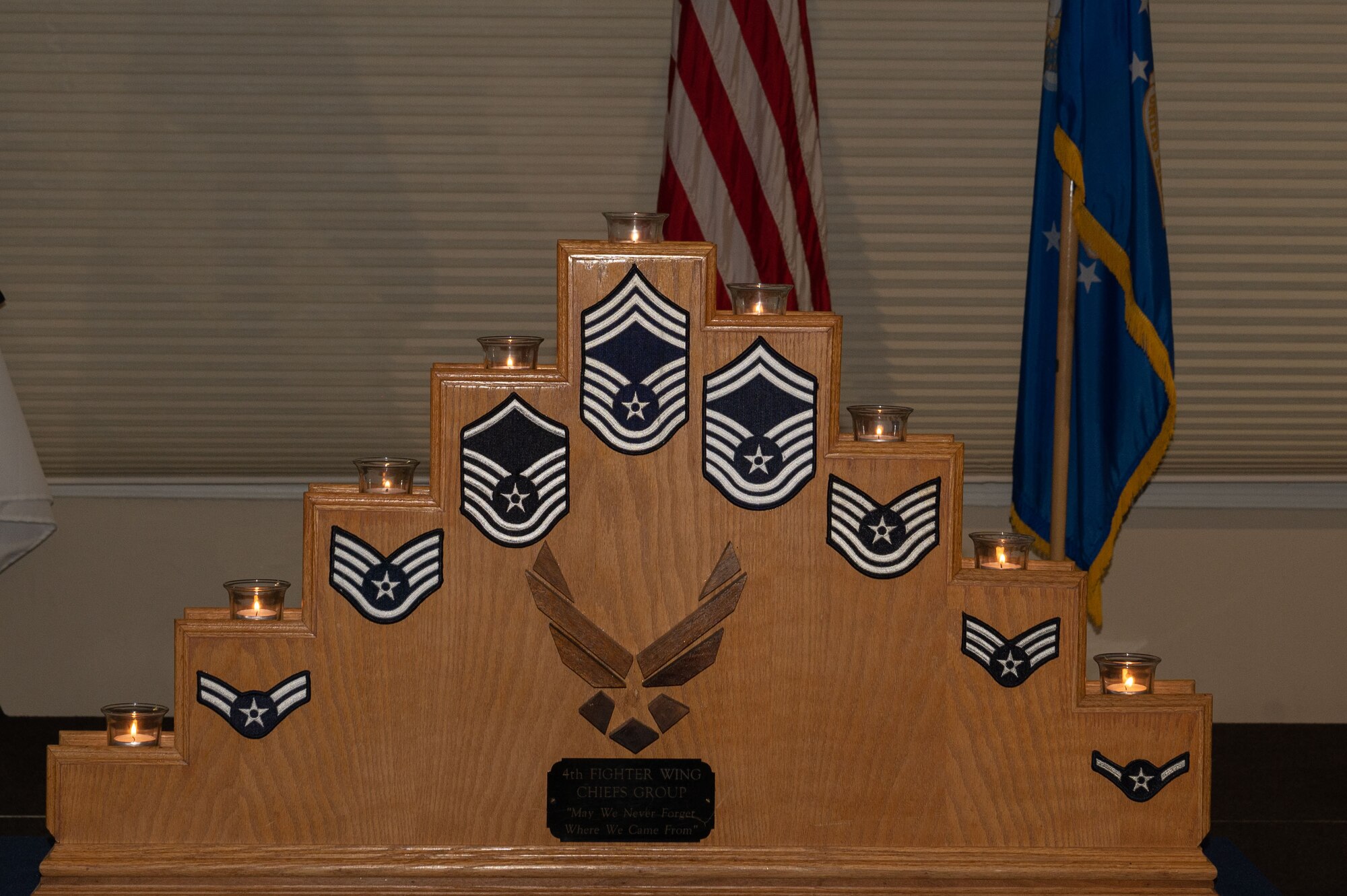 Candles representing each enlisted rank are lit on a podium during a Chief Master Sergeants Recognition Ceremony at Seymour Johnson Air Force Base, North Carolina, March 24, 2023. The candle recognized SJAFB’s newest chief master sergeant selects. (U.S. Air Force photo by Airman 1st Class Rebecca Sirimarco-Lang)