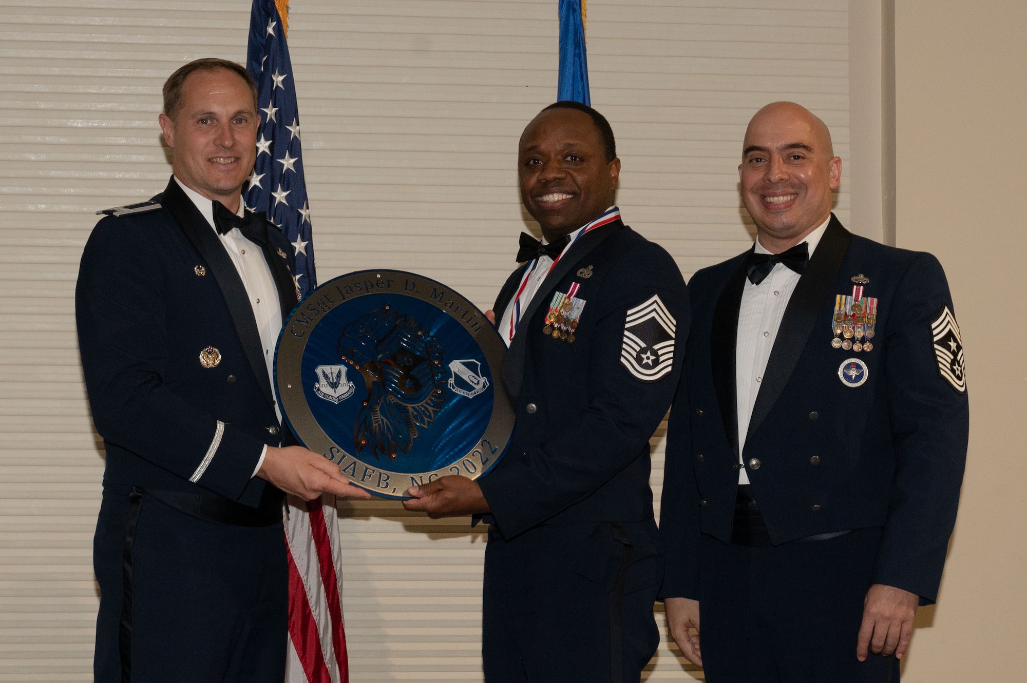 Col. Lucas Teel, 4th Fighter Wing commander, and Chief Master Sgt. Peter Martinez, 4th FW command chief, presents a plaque to Chief Master Sgt. Jasper Martin, 4th Maintenance Group maintenance operations senior enlisted leader, during a Chief Master Sergeant Recognition Ceremony at Seymour Johnson Air Force Base, North Carolina, March 24, 2023. The ceremony honored Seymour Johnson’s newest chief master sergeants and selects for achieving the top enlisted grade in the Air Force. (U.S. Air Force photo by Airman 1st Class Rebecca Sirimarco-Lang)