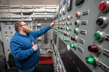 Austin Angle, Shop 99, Temporary Services, pumpwell team, monitors flooding operations inside the caisson at Dry Dock 2 while preparing for a 2019 submarine docking, at Puget Sound Naval Shipyard & Intermediate Maintenance Facility in Bremerton, Washington. (U.S. Navy photo by Scott Hansen)