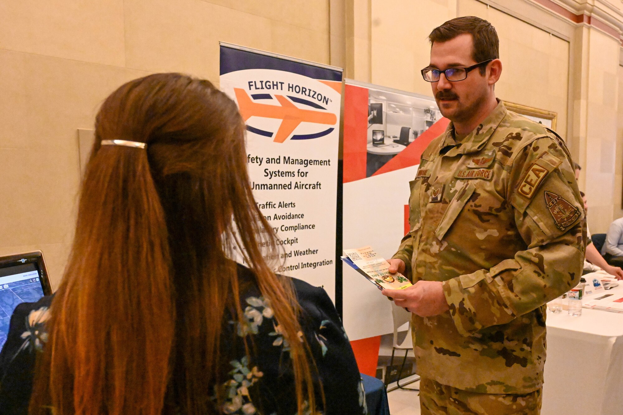 U.S. Air Force Staff Sgt. Jeff Michal, 54th Air Refueling Squadron boom operator instructor, talks with Andrea Jones, Vigilant Aerospace Systems administrative and marketing assistant, at the 2023 AERO Oklahoma Aviation, Aerospace and Defense Awareness at the Oklahoma State Capitol, March 22, 2023. Airmen had the opportunity to visit information booths and learn about the flying community across Oklahoma. (U.S. Air Force photo by Senior Airman Trenton Jancze)