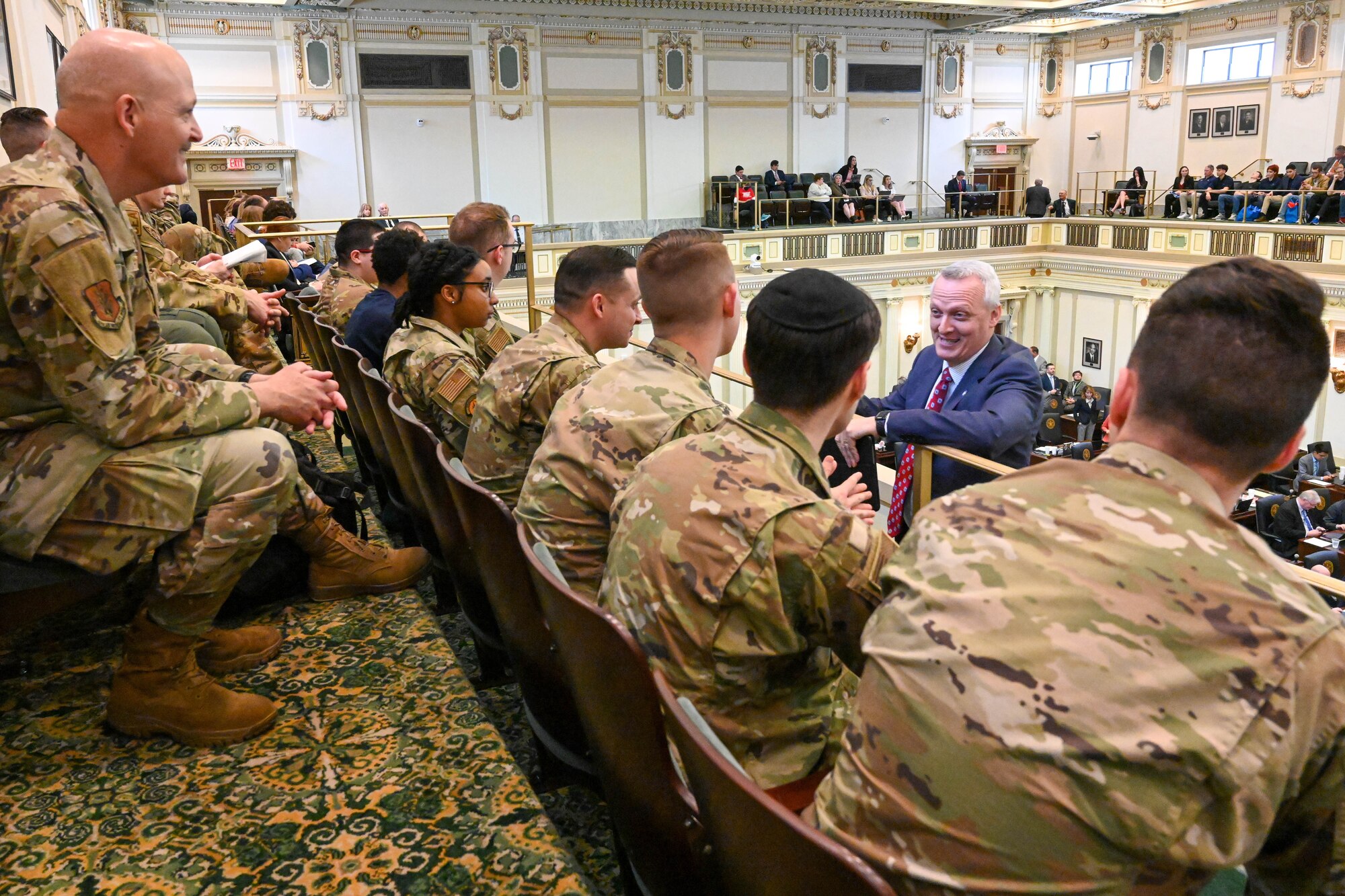 Oklahoma State Rep. Gerrid Kendrix talks with Airmen from the 97th Air Mobility Wing at Altus Air Force Base, Oklahoma, in the state House of Representatives chamber at the 2023 Oklahoma Aviation, Aerospace and Defense Awareness expo at the Oklahoma State Capitol, March 22, 2023. Airmen observed live proceedings in the House of Representatives during their brief tour with Kendrix. (U.S. Air Force photo by Senior Airman Trenton Jancze)