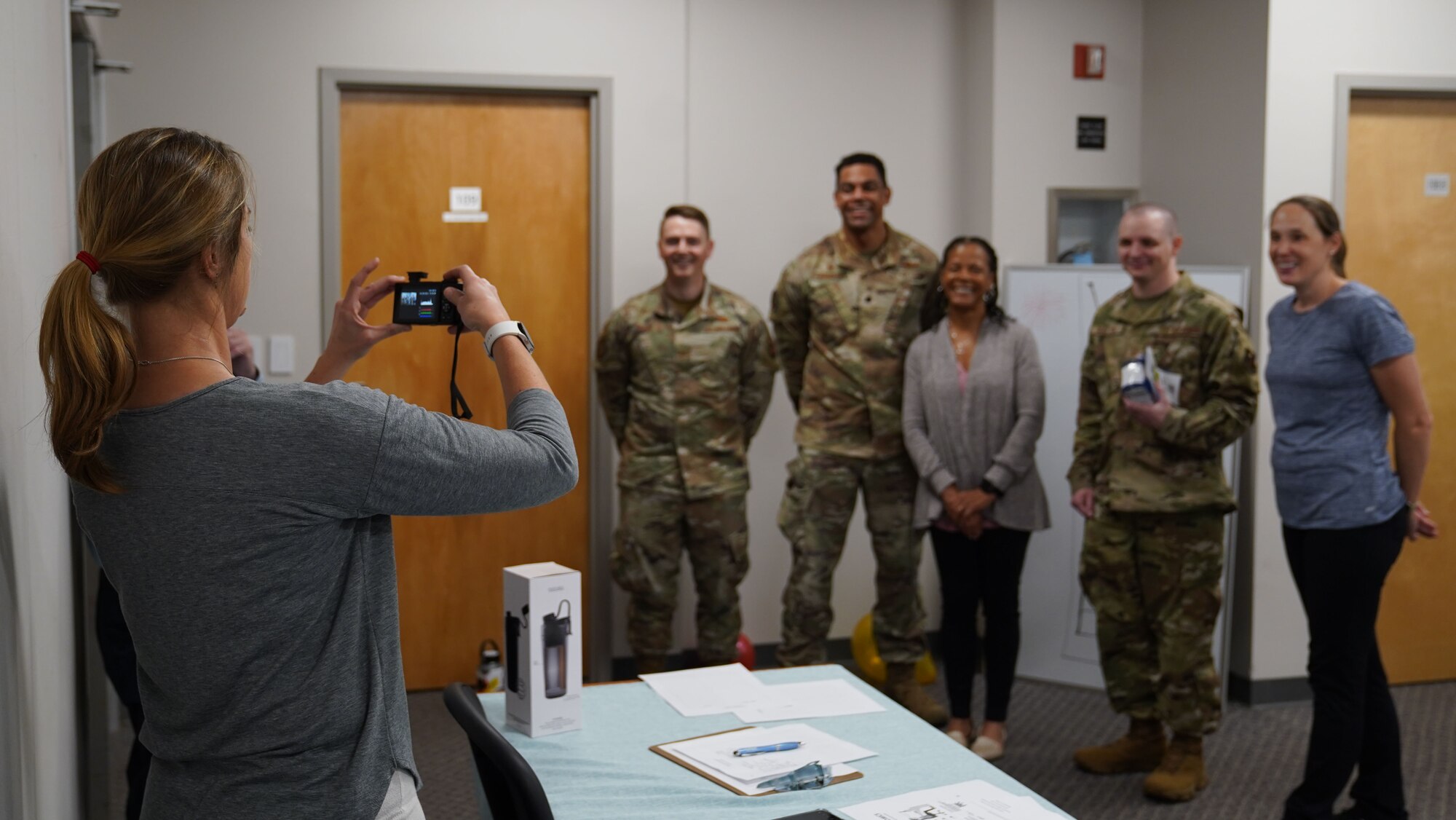 Mary Ruffin, 81st Training Wing Operational Support Team licensed clinical social worker, takes a photo of attendees of the Dragon Blitz event in the Vosler Center on Keesler Air Force Base, Mississippi, March 28, 2023.