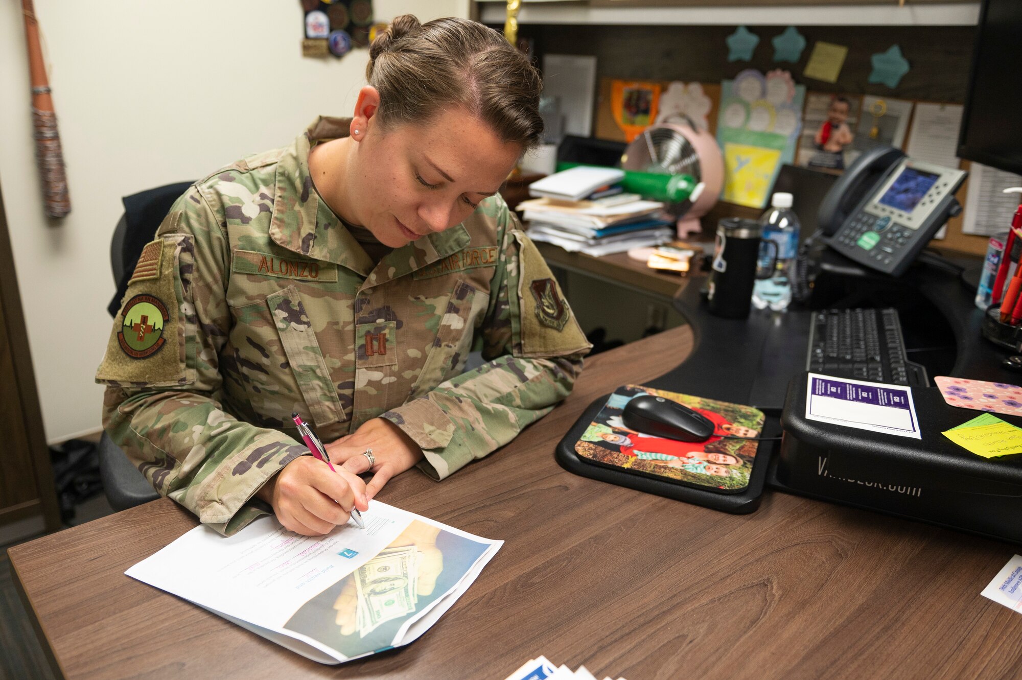U.S. Air Force Capt. Britney Alonzo, 36th Healthcare Operations Squadron TRICARE operations and patient administration flight commander, works on a packet that she received from the Financial Peace University course on Andersen Air Force Base, Guam, March 21, 2023. The FPU course was a nine-week course that covered nine main lessons including cash flow planning, dumping debt, the role of insurance, retirement and college planning, real estate and mortgages. (U.S. Air Force photo by Airman 1st Class Spencer Perkins)
