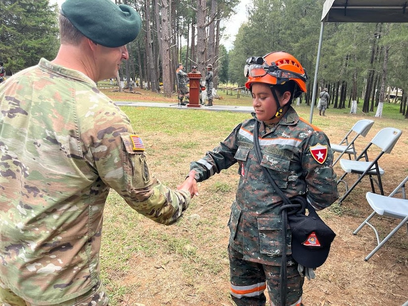 U.S. Army COL Phillip Brown, Joint Task Force commander, coins one of the soldiers from the Batallon Humanitario y de Rescate following her demonstration and complements her hard work Mar 27, 2023. Joint Task Force Bravo Commander visits with regional partners and Civil Affairs teams in Guatemala from 22 - 29 March 2023 to reaffirm the task forces commitment to our regional partners and discuss how to strengthen respective partnerships.