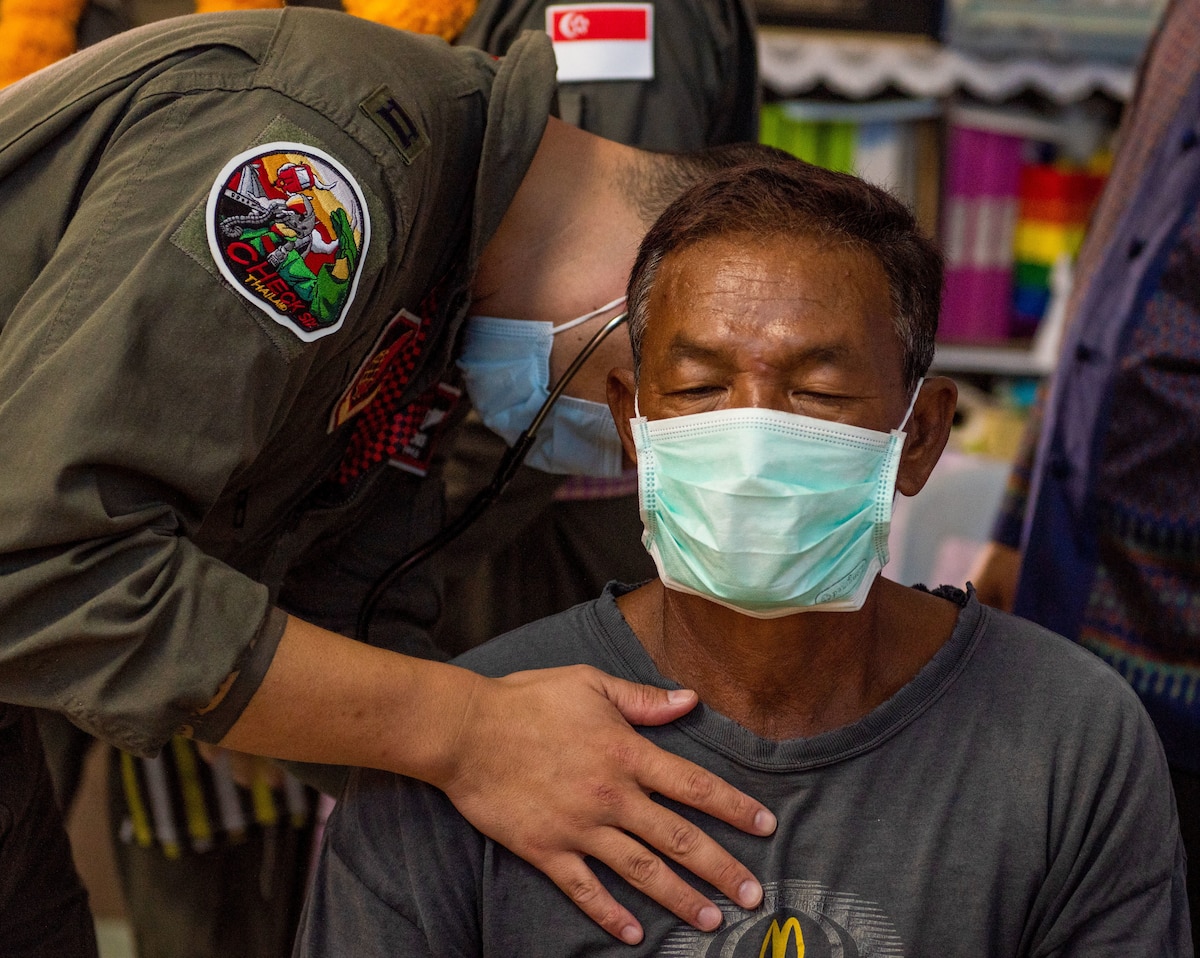 Photo of a U.S. Air Force flight surgeon examination a patient during a civic action engagement.