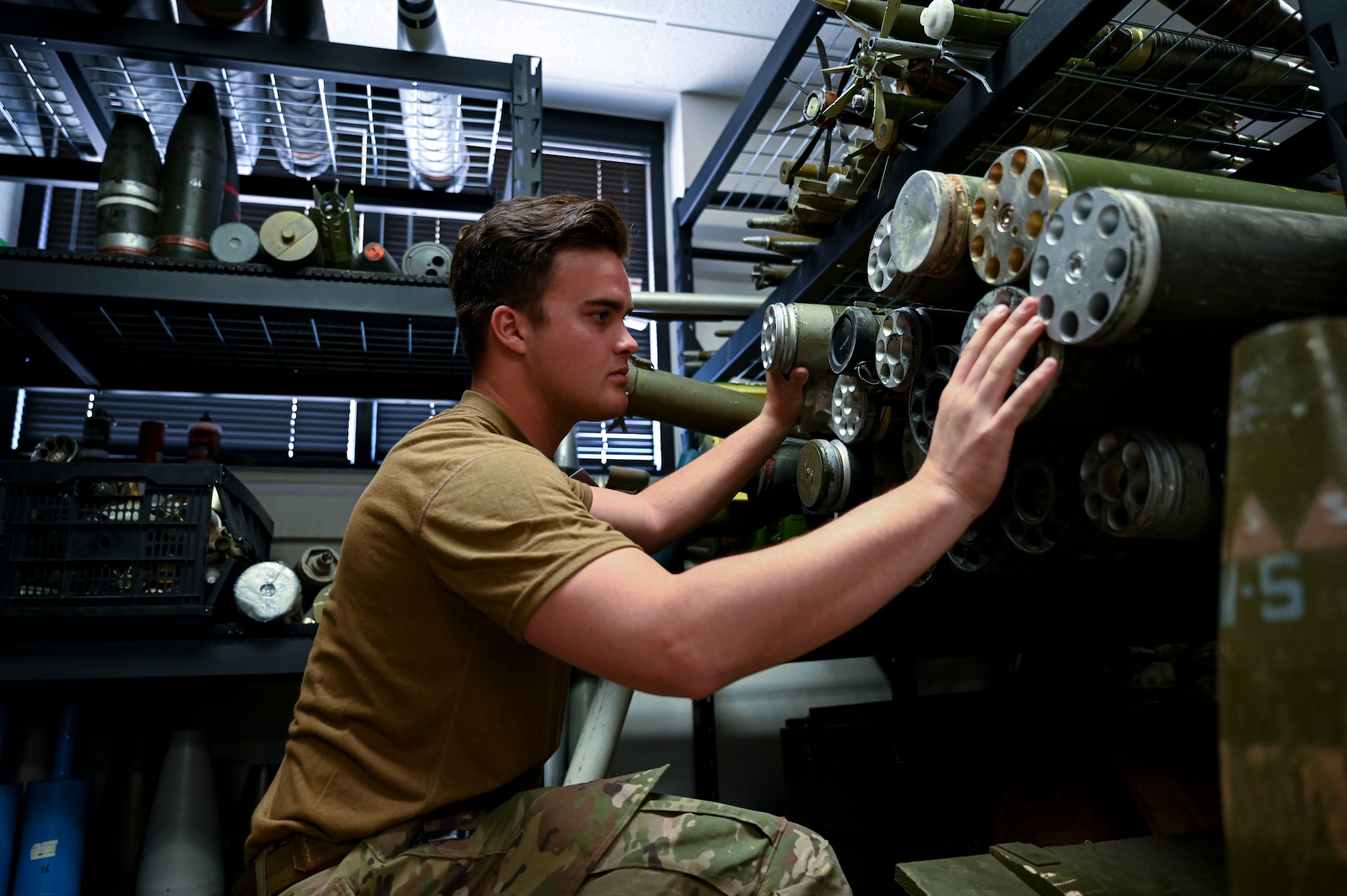 U.S. Air Force Airman 1st Class Ryan Lawson, 49th Civil Engineer Squadron explosive ordnance disposal apprentice, sorts through an array of mock explosive munitions at Holloman Air Force Base, New Mexico, March 23, 2023. The 49th CES EOD flight is trained to disarm and dispose of any explosives or chemicals that pose a threat to personnel on base. (U.S Air Force photo by Airman 1st Class Isaiah Pedrazzini)