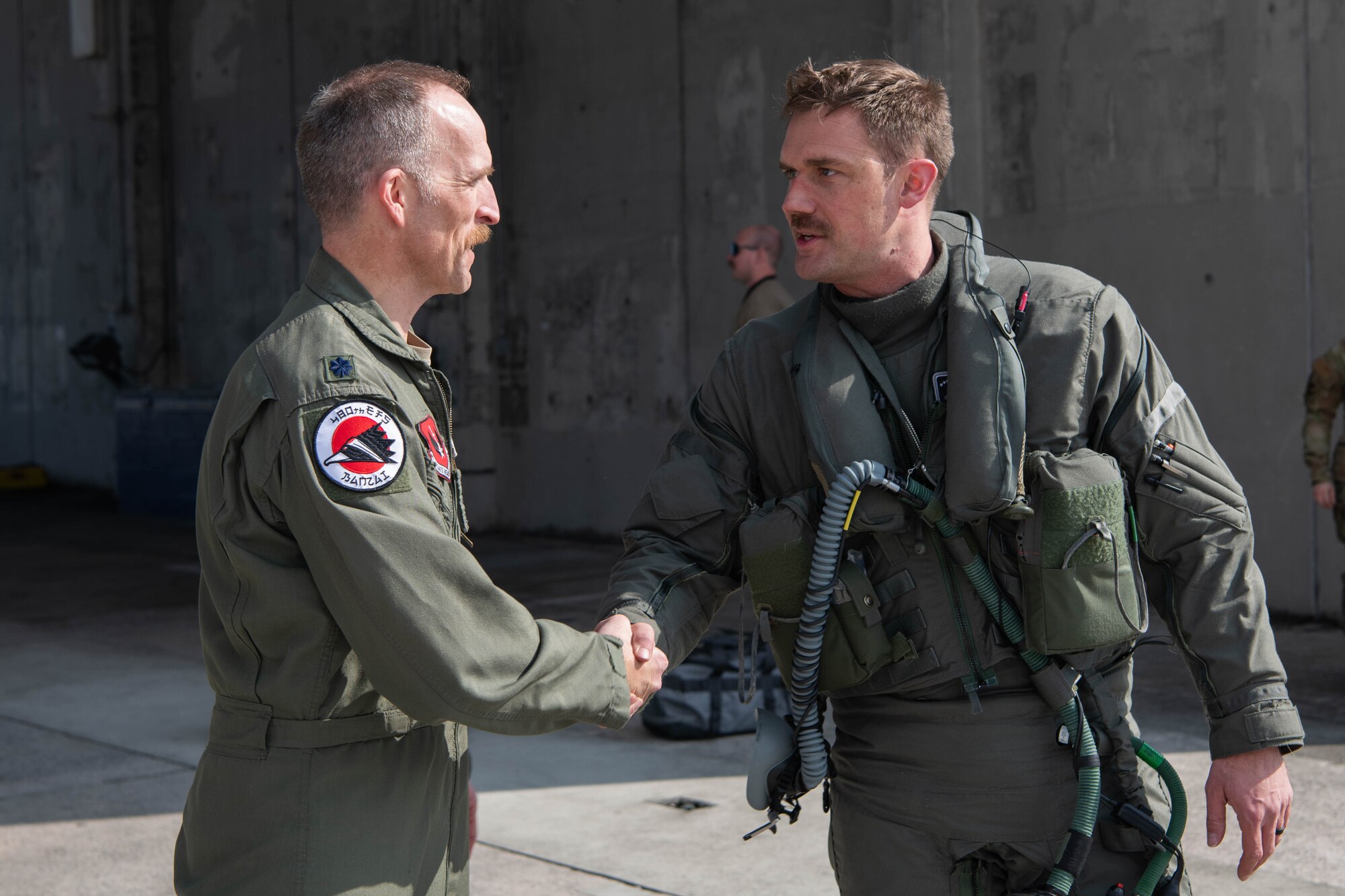 Airmen shake hands.