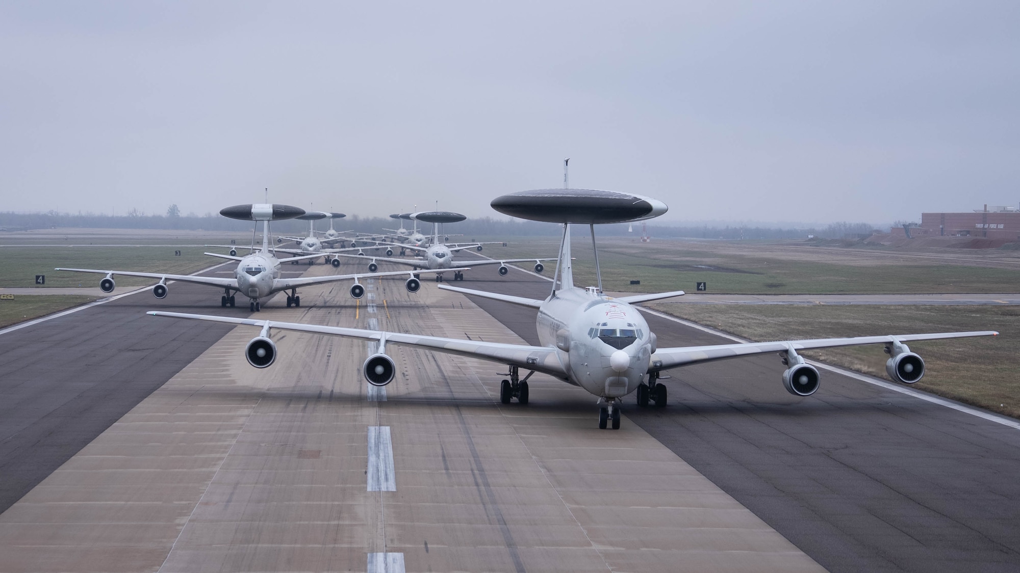 Seven E-3G Sentry aircraft lined up on runway