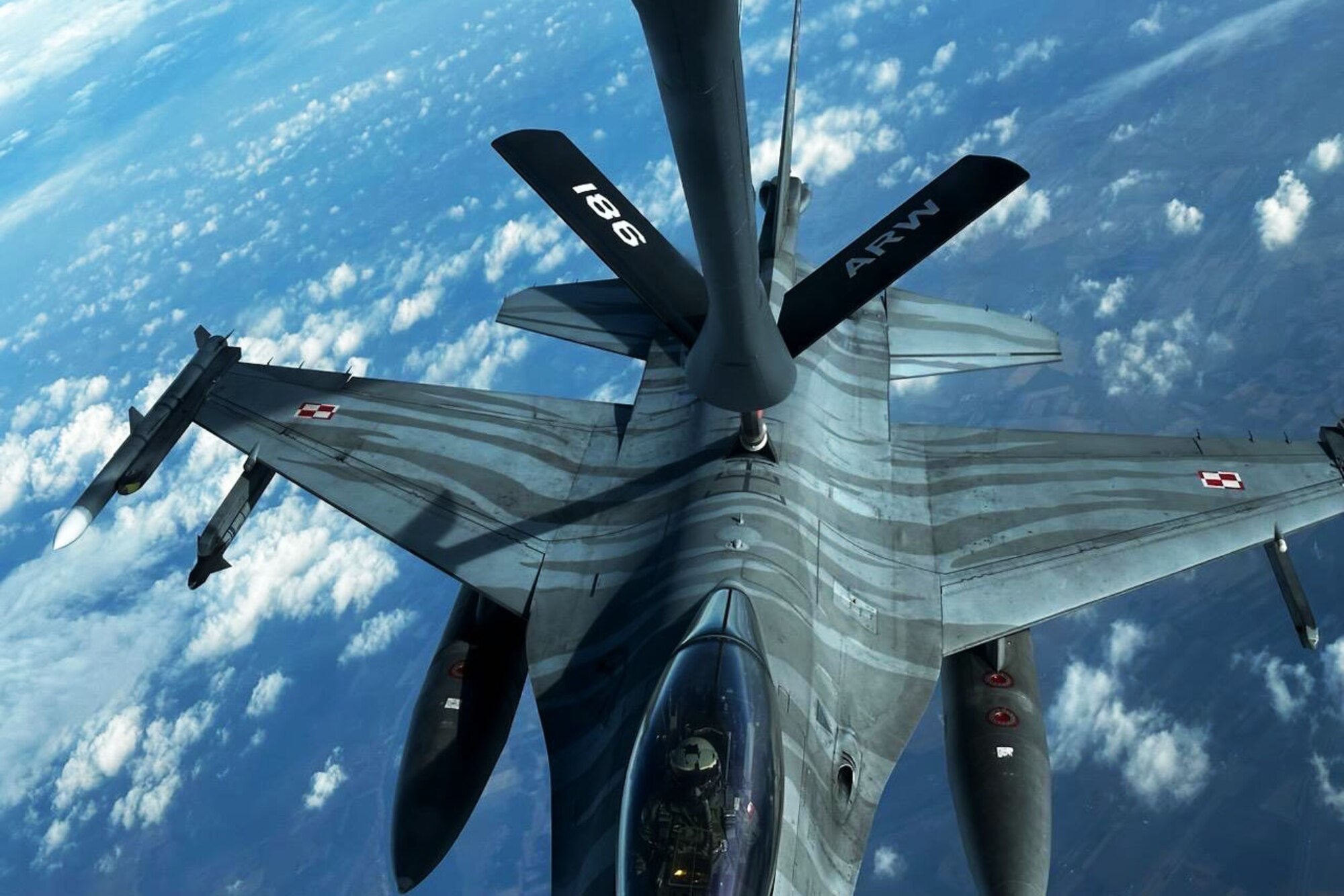 A plane refuels another plane in mid-air.