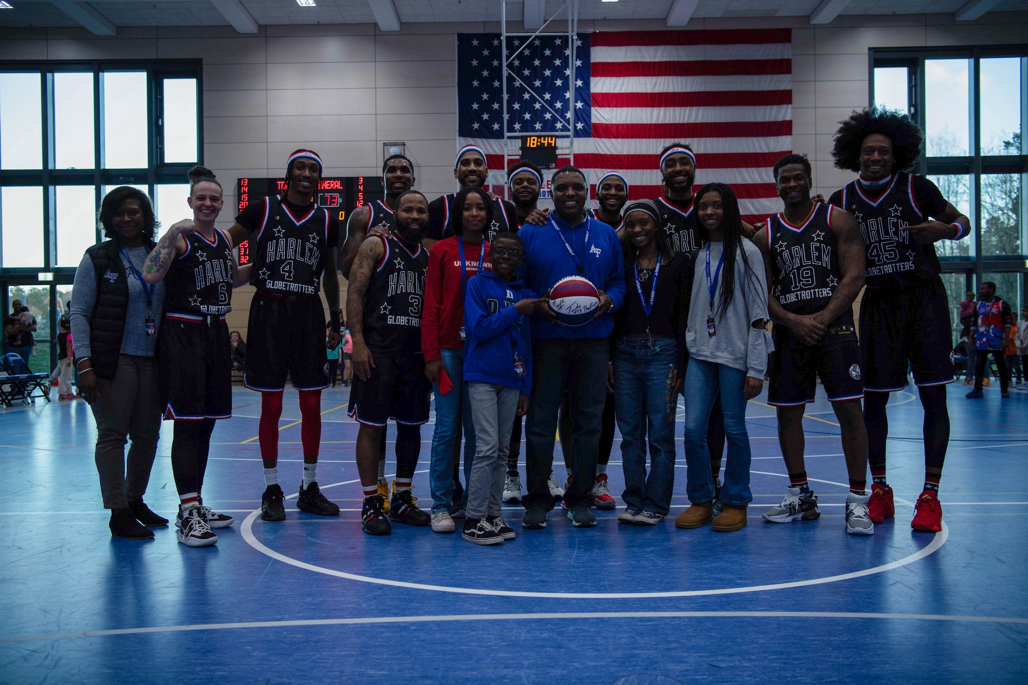 U.S. Air Force Brig. Gen. Otis C. Jones, 86th Airlift Wing commander, and his family pose with the Harlem Globetrotters at Ramstein Air Base, Germany, March 24, 2023.