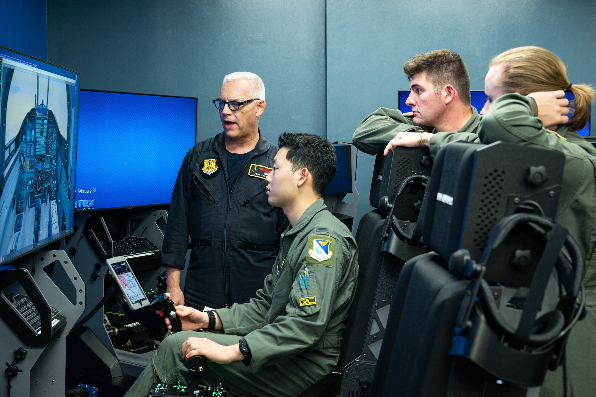 John Stipo (left), 47th Operation Group simulator instructor, informs undergraduate pilot training students on the basics of flying a T-38 Talon using a simulator on Feb. 22, 2023, at Laughlin Air Force, Texas. Laughlin uses top-of-the-line simulators to simulate different aircraft, environments, and
scenarios. (U.S. Air Force photo by Senior Airman David Phaff)