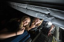 Mersadie Rhoades from Tabiona High School and Catarina Stefanoff from Delta High School lay in the fueler pit of a KC-135 Stratotanker while visiting Roland Wright Air National Guard Base, July 13, 2022. Since 1961, the Utah National Guard and Honorary Colonels Corps have sponsored Freedom Academy and provided a challenging and engaging environment designed to teach young leaders the importance of freedom and that leadership is essential to its survival. (U.S. Army photo by Staff Sgt. Ariel Solomon)