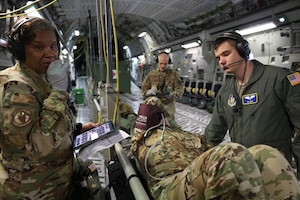 Lt. Col. Jenice Brown and Capt. Neil Ehmig, both flight nurses with the 445th Aeromedical Evacuation Squadron, check the vitals on a mock patient onboard a 445th Airlift Wing C-17 Globemaster III March 21, 2023. The training took place while they were enroute to Keesler Air Force Base, Mississippi with a follow on to St. Croix, U.S. Virgin Islands. The two were among six reservists from the 445th AES that participated in Dissimilar Aircraft Refresher Training (DART) at St. Croix March 21 – 23, 2023.