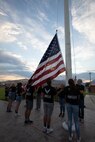 Delegates participate in a flag raising ceremony