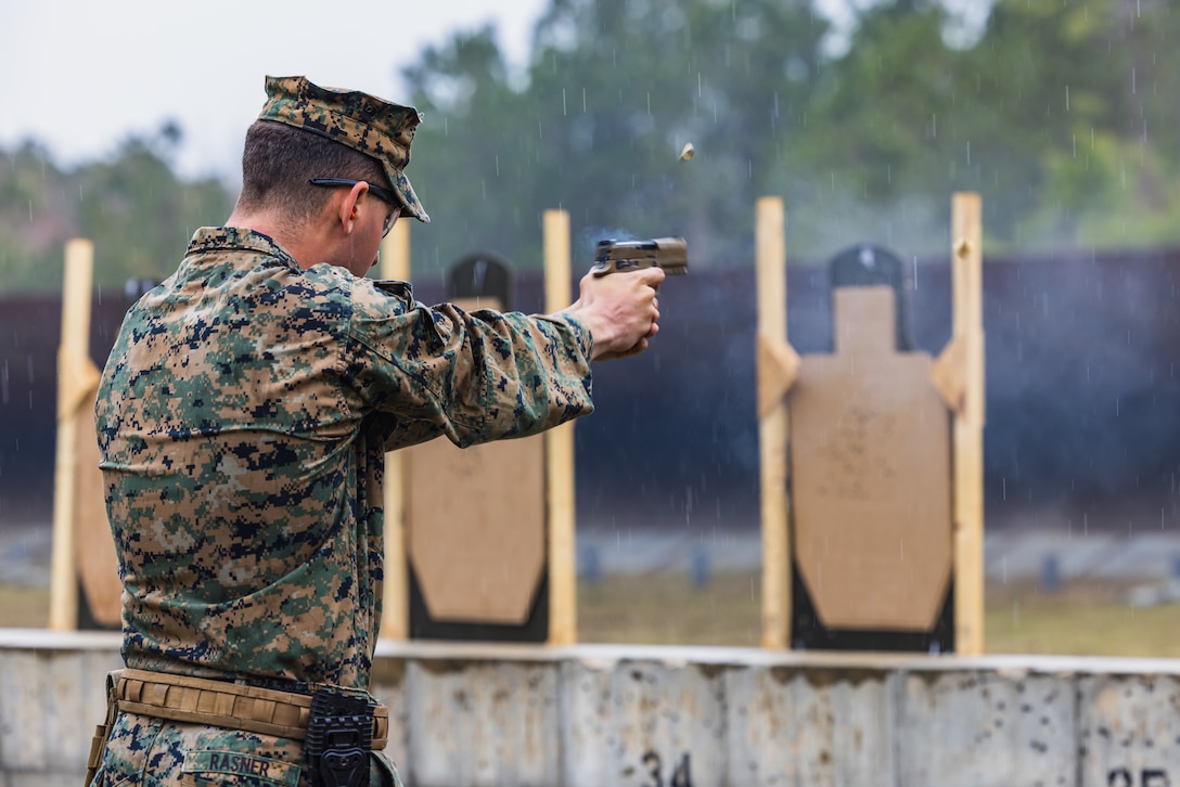 A U.S Marine fires a pistol during the 2023 Marine Corps Marksmanship Competition East on Stone Bay, Marine Corps Base Camp Lejeune, North Carolina, March 10, 2023. All Marines east of the Mississippi were invited to attend this annual competition to increase their combat effectiveness and lethality using MCB Camp Lejeune's premier ranges.