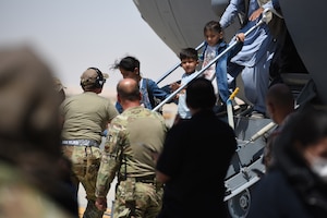 Afghan evacuees leave a U.S. C-17 Globemaster after arriving to Ali Al Salem Air Base, Kuwait, Aug. 26, 2021. The Department of Defense supported the evacuation of U.S. citizens, Special Immigrant Visa applicants and other at-risk individuals from Afghanistan.