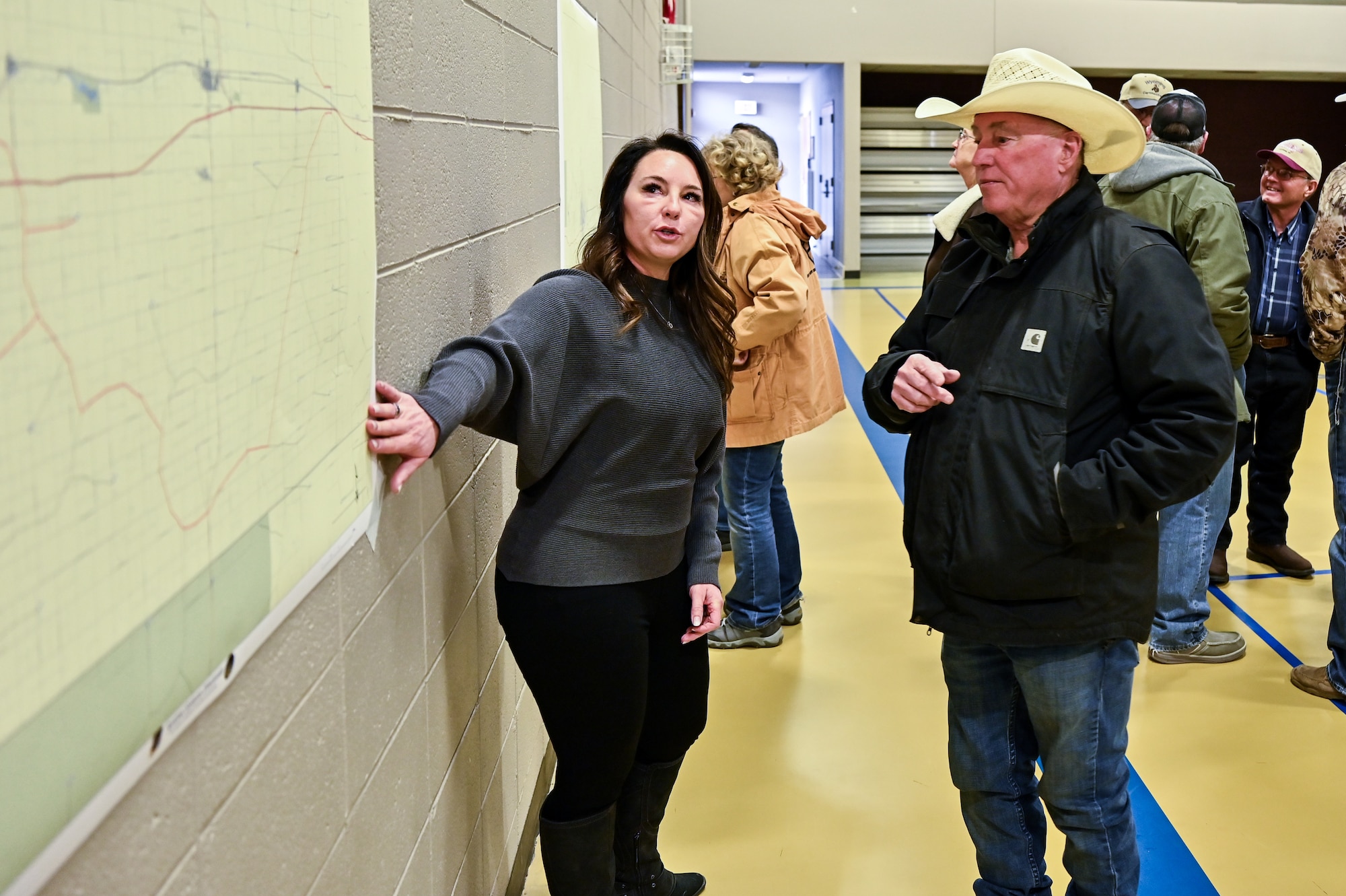 Heather Gray, Air Force Nuclear Weapons Center Sentinel real estate acquisition program manager, talks with a landowner during a town meeting in Pine Bluffs, Wyoming, March 27, 2023. The U.S. Air Force and the U.S. Corps of Engineers host a Sentinel town meeting for Laramie County landowners to discuss real estate activities and future negotiations to support the project. The Air Force discussed the temporary construction easements for utility corridors and launch facilities and missile alert facilities conversion; the new permanent easements for utility corridors; drainage easements for LF and MAF sites converted to the new Sentinel Launch Centers; road access to new tower sites; and fee acquisitions for five-acre tower sites. (U.S. Air Force photos by Joseph Coslett Jr.)