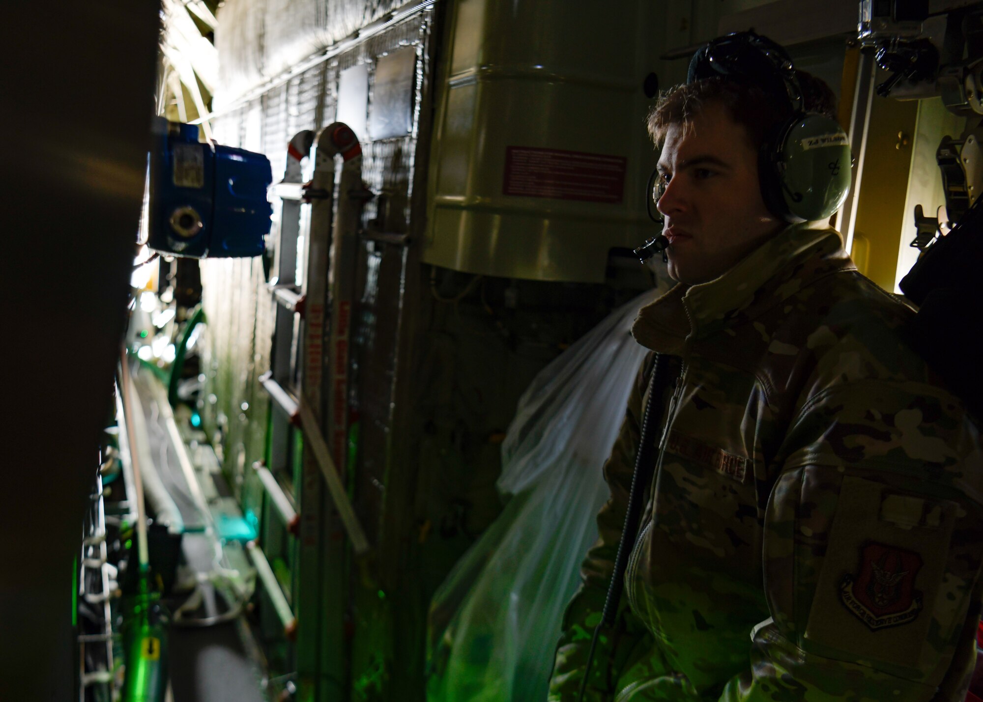 Staff Sgt. Zachery Wilson, an aerial spray system maintainer assigned to the 910th Maintenance Squadron, monitors the product loading of an electronic modular aerial spray system aboard an aerial spray modified C-130H Hercules aircraft assigned to the 910th Airlift Wing, Youngstown Air Reserve Station, Ohio, on March 14, 2023, at Hill Air Force Base, Utah.