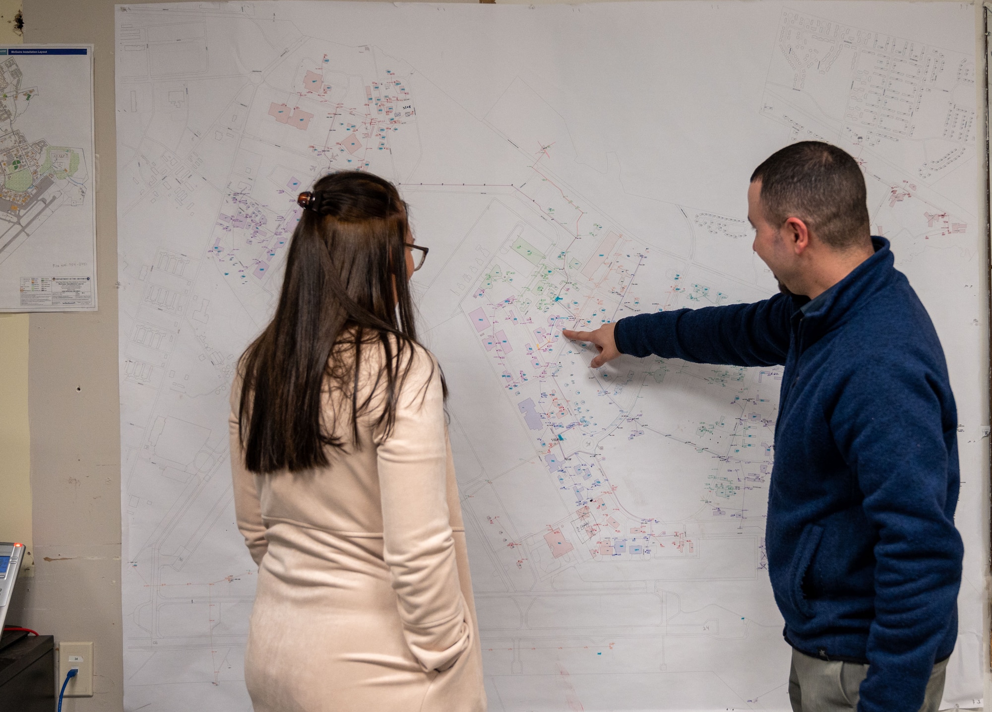 Alaina Campioni, 787th CES cartographer and Robert Gullo, 787th Civil Engineer Squadron Geobase and Execution support chief, locate a building using a physical map at Joint Base McGuire-Dix-Lakehurst, N.J., March 20, 2023. JB MDL is now equipped with a state-of-the-art online map system, Portal Maps, that is both innovative and efficient.