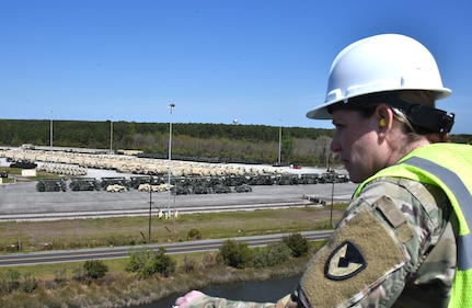 Maj. Janessa Moyer, director of the U.S. Army Medical Materiel Agency’s Force Projection Directorate, stands topside of the USNS Pomeroy (T-AKR 316) overlooking prepositioned stocks that are ready to load onto the ship at port in Charleston, South Carolina. The Pomeroy is a roll on/roll off cargo vessel – one of several in the Military Sealift Command inventory – that transports and stores military equipment and supplies as part of the Army Prepositioned Stocks, or APS, program. (Photo Credit: Ellen Crown)